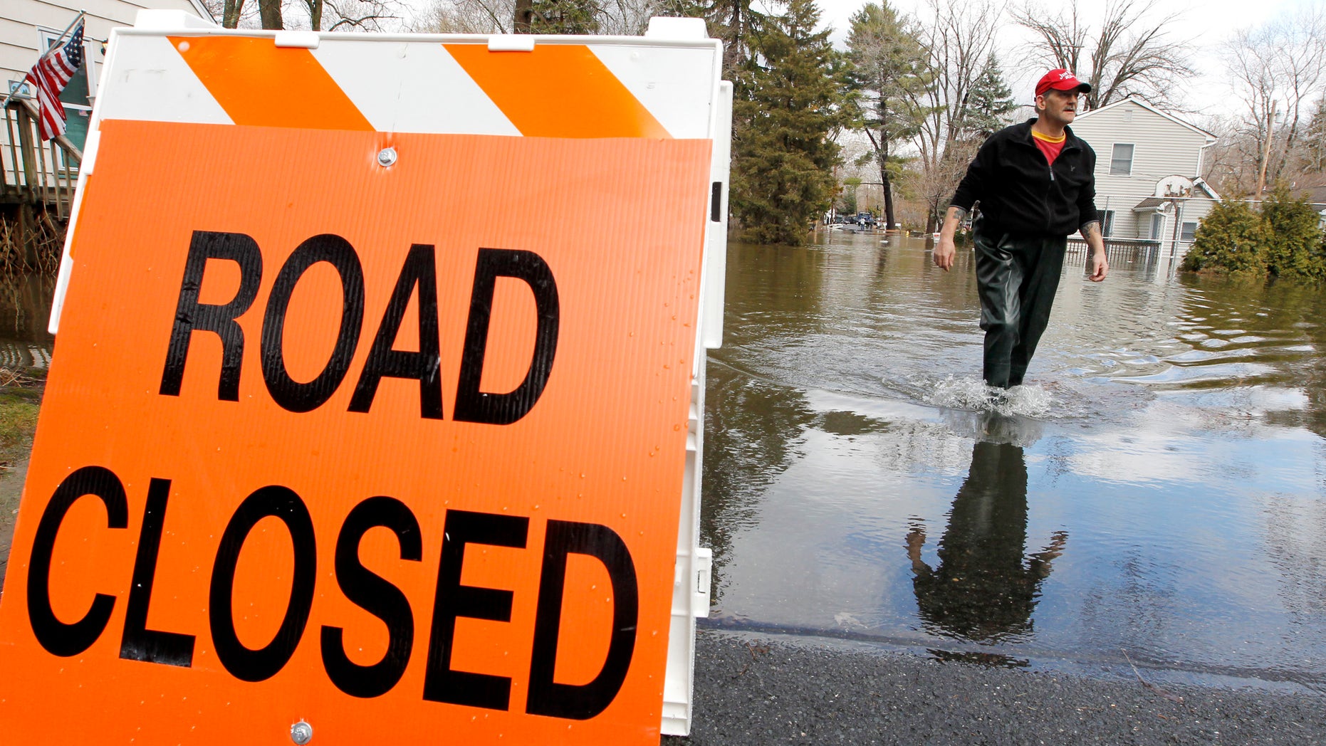 George Ruby, of the Riverview Community in Wayne, N.J., wades through water on his street, Friday, March 11, 2011. The water levels rose Friday morning, following a storm that hit the northern New Jersey region.
