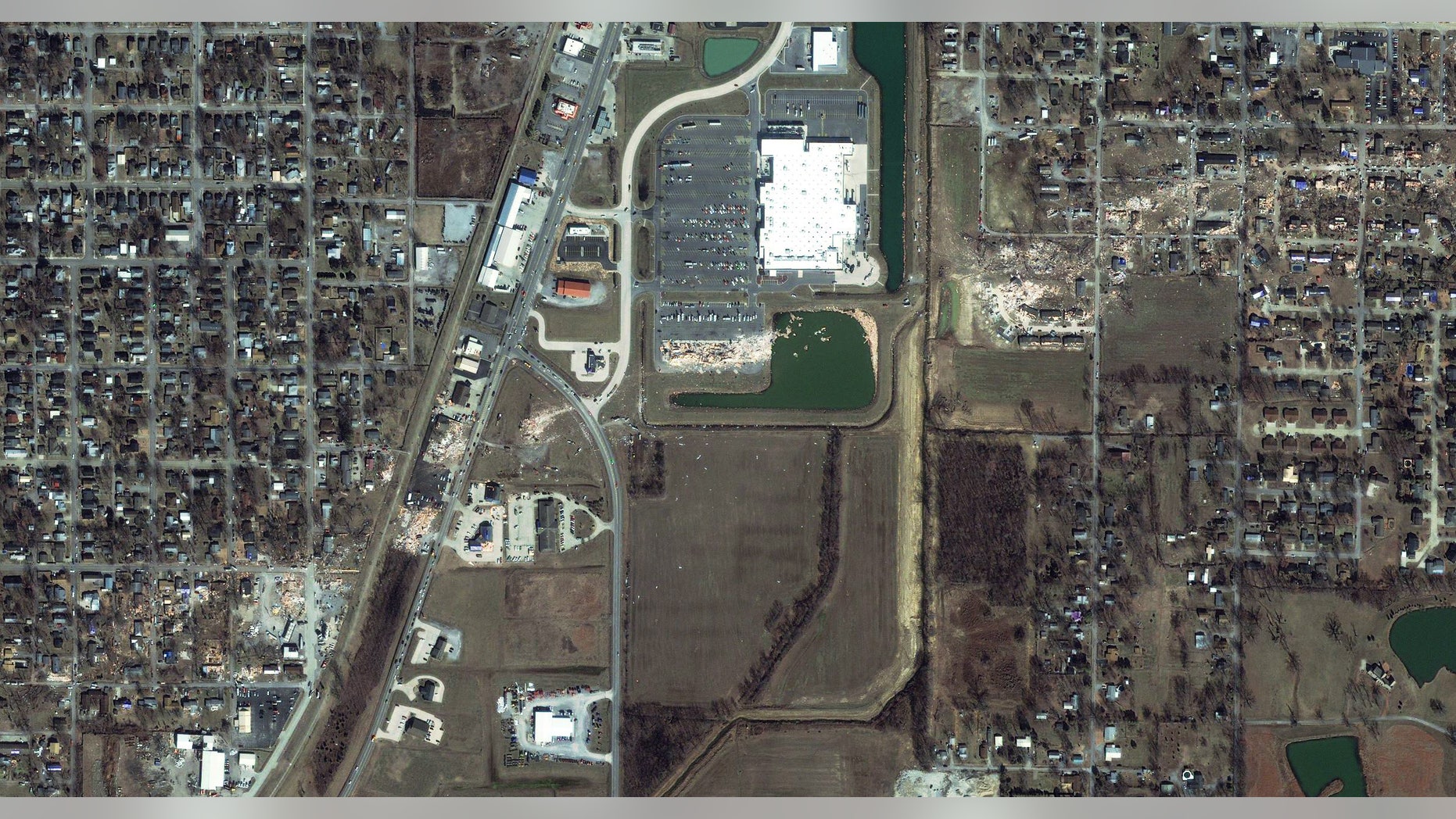 March 1: This satellite image provided by GeoEye shows the path of a tornado, diagonal from bottom left to upper right, which struck Harrisburg, Ill.