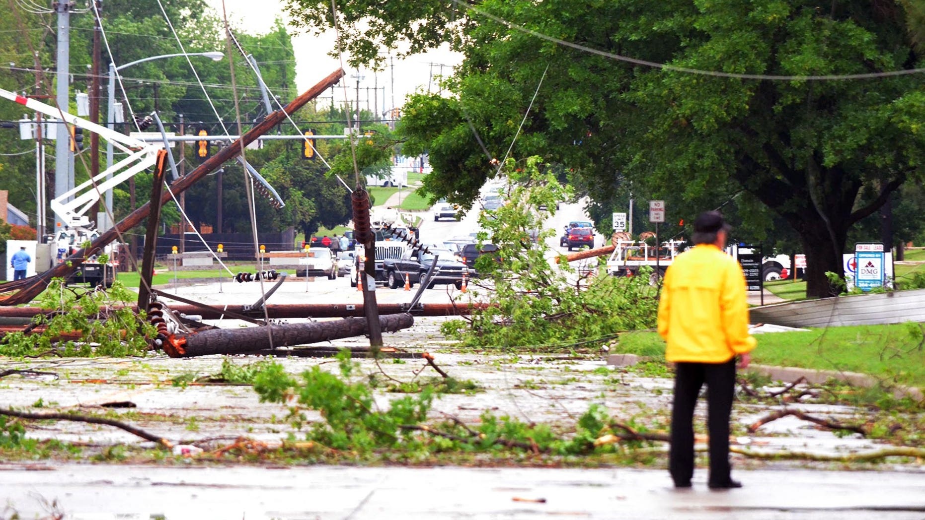 April 13, 2012: An emergency worker stands in the intersection of Lindsey Street and 24th Avenue Southwest after a tornado passed through, Friday afternoon in Norman, Okla