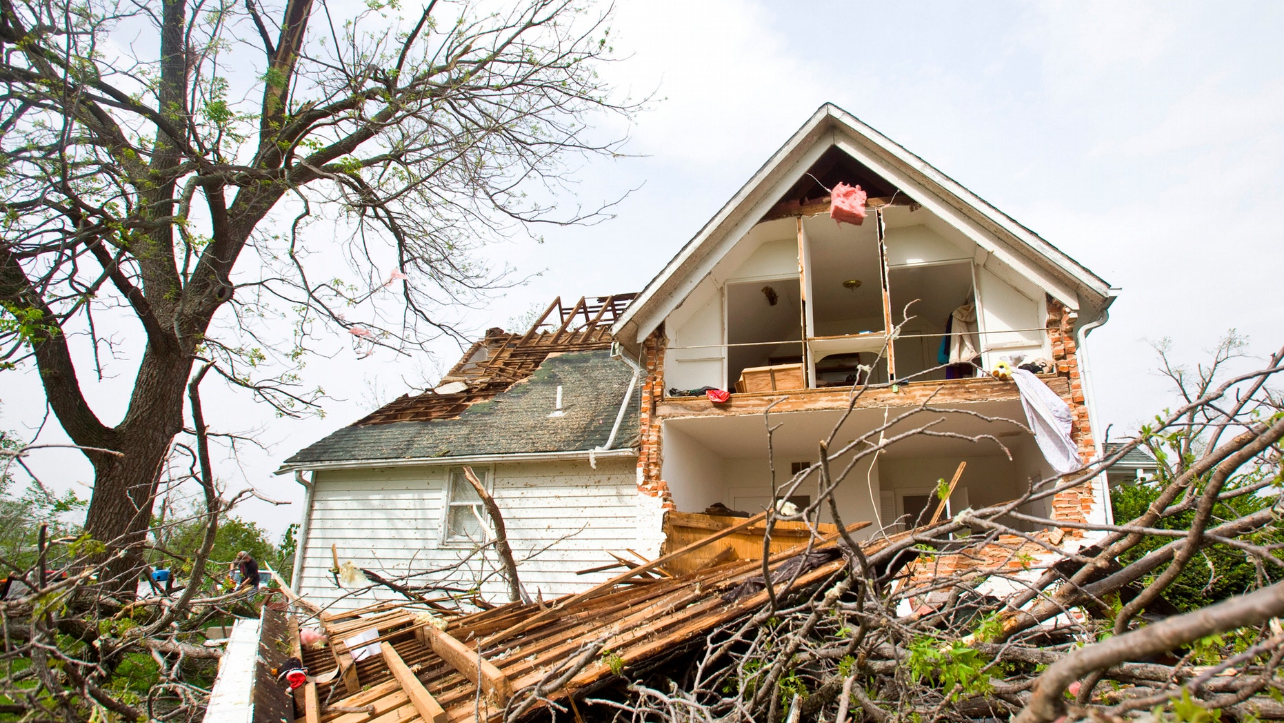 A house sits ripped-open from a tornado on Sunday, April 15, 2012 in Thurman, Iowa. Thurman appeared to be the hardest hit community in Iowa, but storms caused damage elsewhere in the state, as well as in Nebraska. There were more than 100 reports of tornadoes across the middle of the country through dawn Sunday, forecasters said. (AP Photo/The Journal-Star, Patrick Breen)