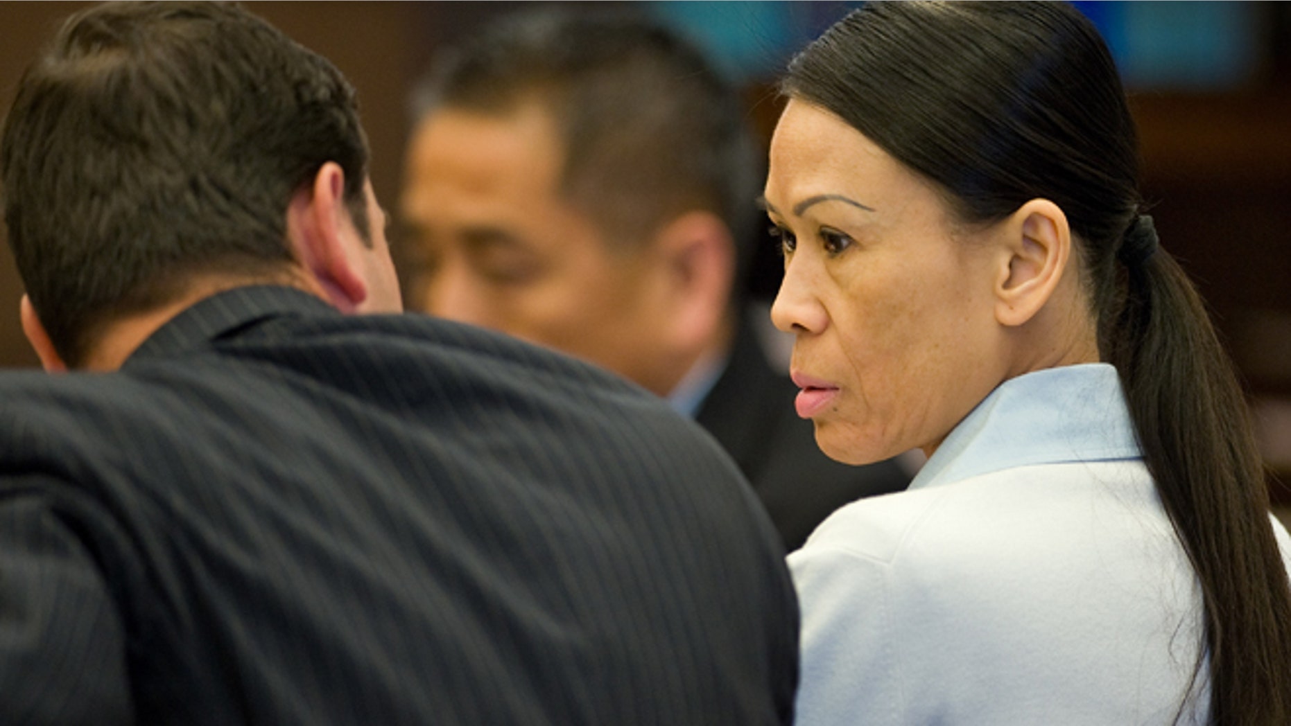 April 17: Catherine Kieu sits next to her attorney. Kieu is charged with cutting off a man's penis and throwing it into a garbage disposal.