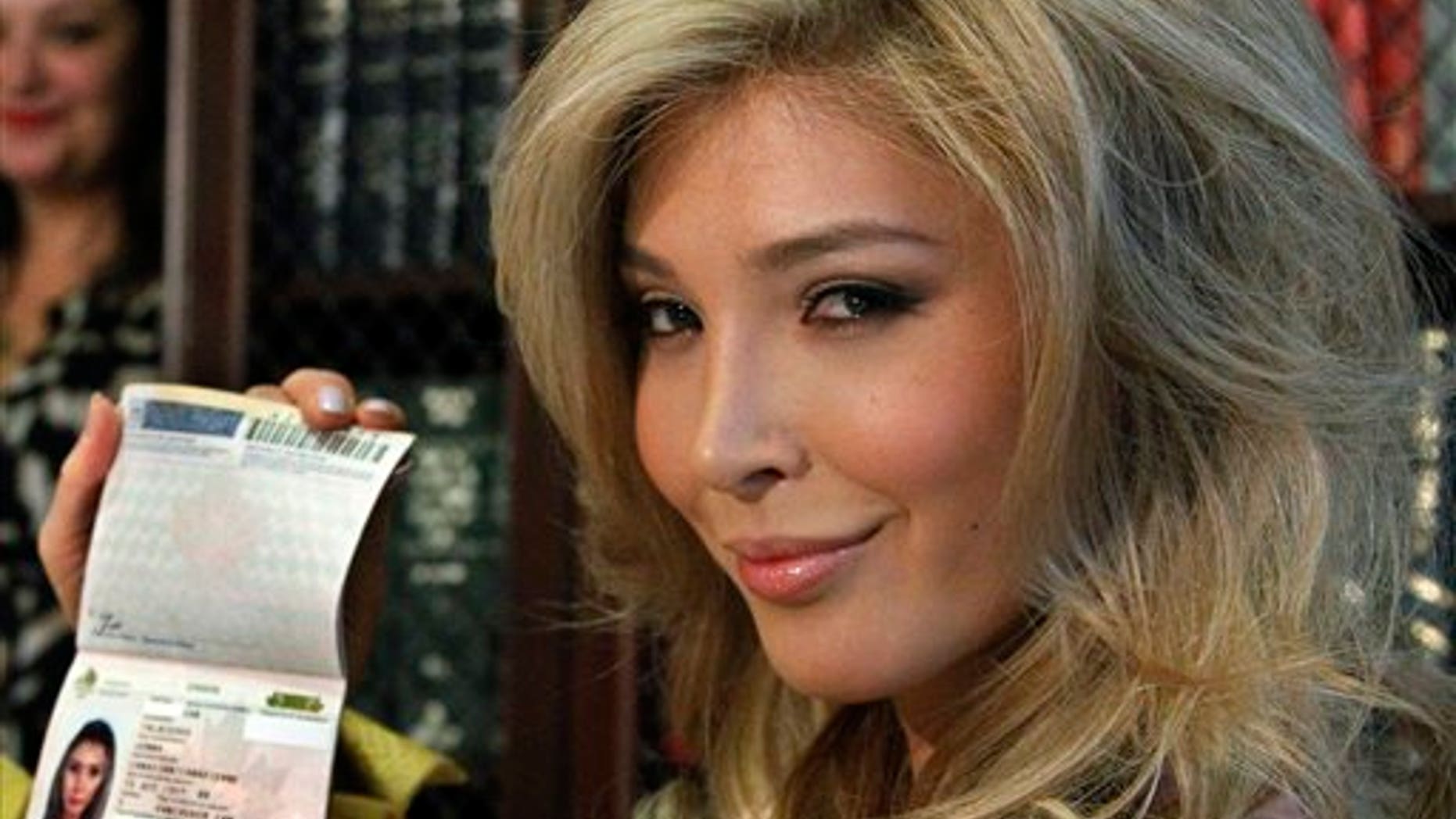 April 3: Jenna Talackova, who advanced to the finals of the Miss Canada competition, part of the Miss Universe contest, and was recently forced out of the competition, shows her passport that lists her gender as female, at a news conference in Los Angeles.