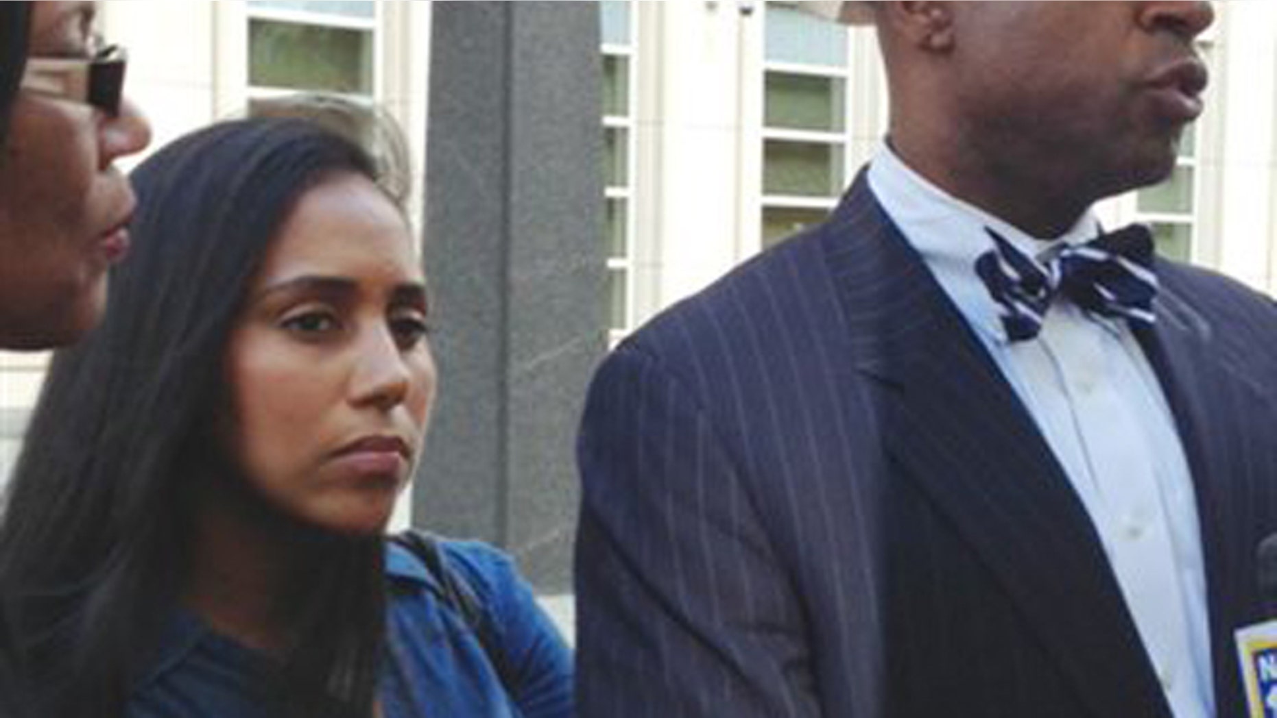 FILE- In this July 3, 2013 file photo, former Metropolitan Detention Center guard, Nancy Gonzalez, center, listens as her attorney, Anthony Rico, speaks to members of the media outside the federal courthouse in the Brooklyn borough of New York. Gonzalez gained notoriety by conceiving a baby behind bars with a cop killer. Although she claims to have had clandestine sexual encounters with at least eight co-workers and a second inmate while on duty at the Metropolitan Detention Center, it remains unclear if anyone else has been disciplined. (AP Photo/Tom Hays, File)