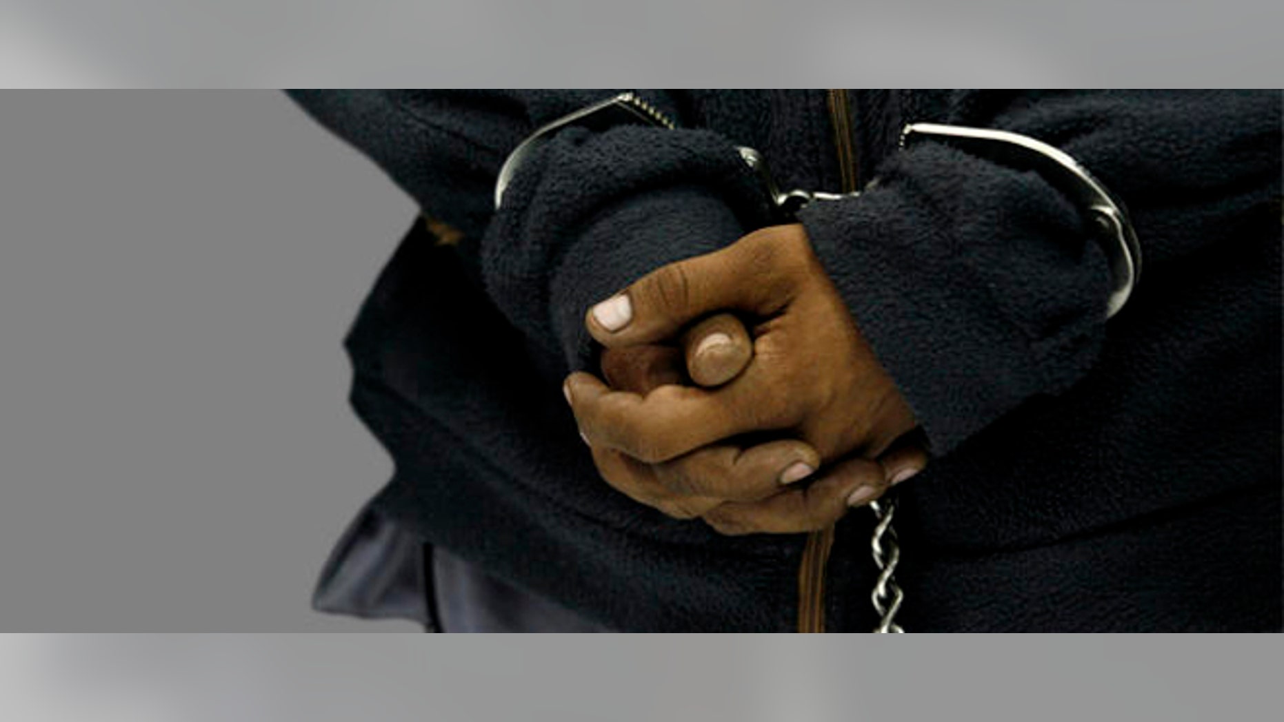 The hands of Raul Ortiz Gonzalez, an alleged member of kidnapping gang "Los Rojos," are handcuffed as he is presented to the press after his arrest in Mexico City, Wednesday, July 29, 2009. Ortiz is a suspect in the 2007 kidnapping and murder of Silvia Vargas. (AP Photo/Marco Ugarte)
