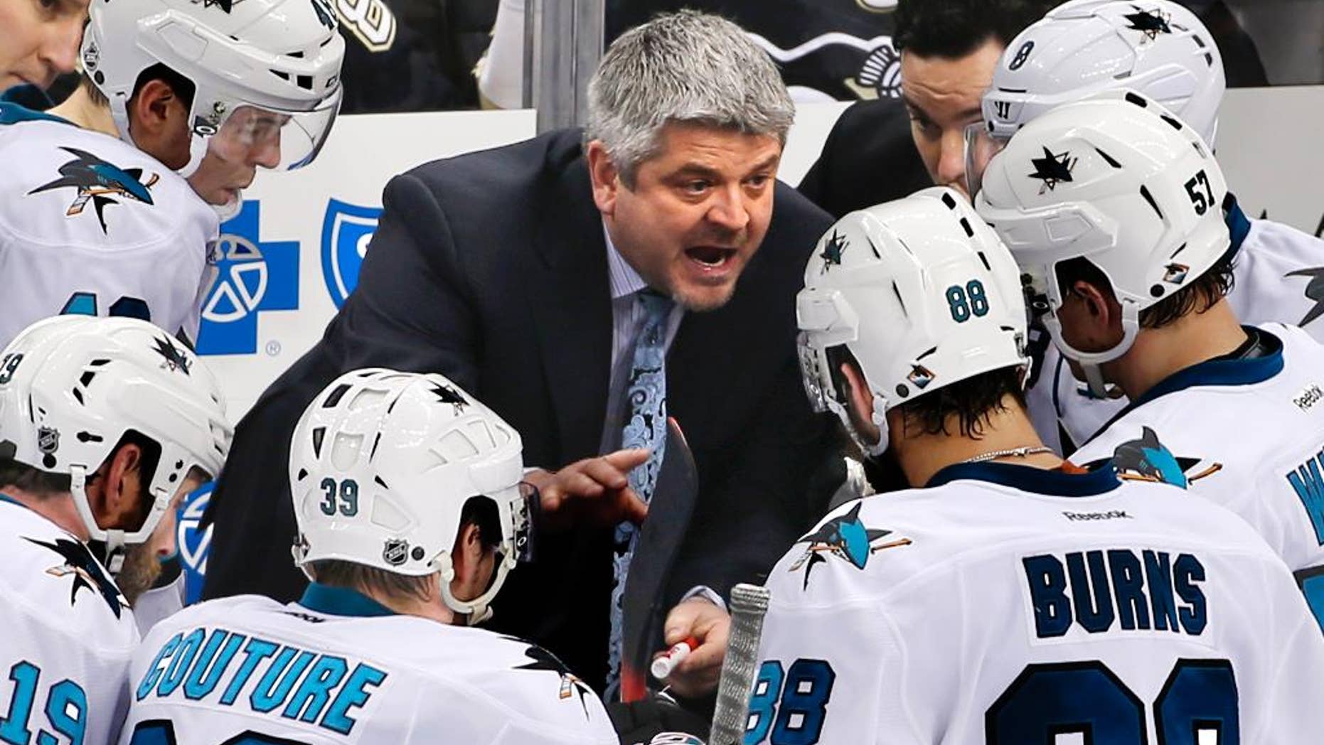FILE - In this March 29, 2015, file photo, San Jose Sharks head coach Todd McLellan, center, talks to his team during a timeout in the third period of an NHL hockey game against the Pittsburgh Penguins in Pittsburgh. The Sharks announced Monday, April 20. 2015, that they had agreed to part ways with McLellan, the winningest coach in franchise history after the team missed the playoffs for the first time since 2003. (AP Photo/Gene J. Puskar, File)