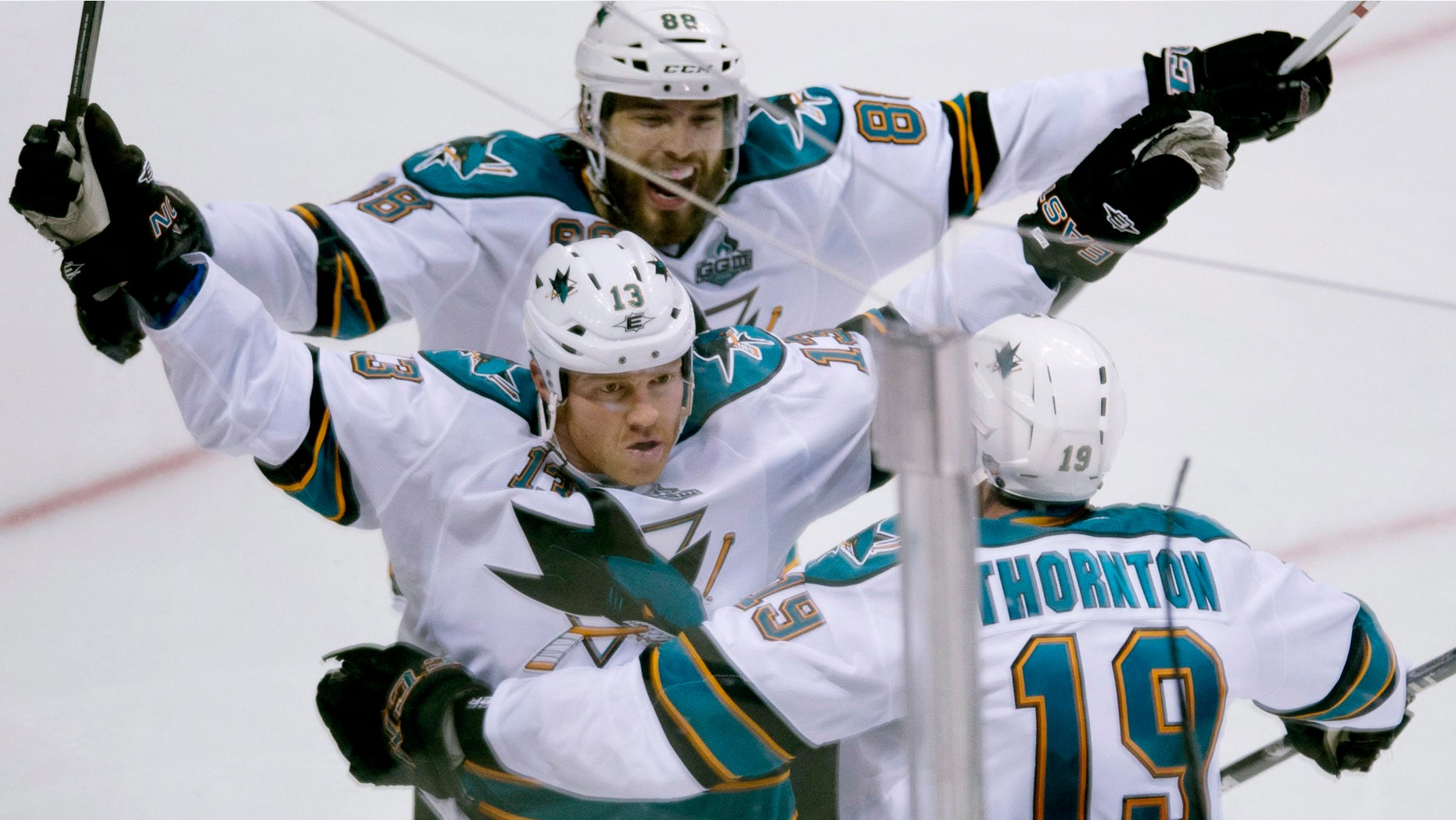 San Jose Sharks Raffi Torres (13) celebrates his game winning goal over the Vancouver Canucks with San Jose Sharks Joe Thornton (19) and Brent Burns (88) on Friday, May 3, 2013.