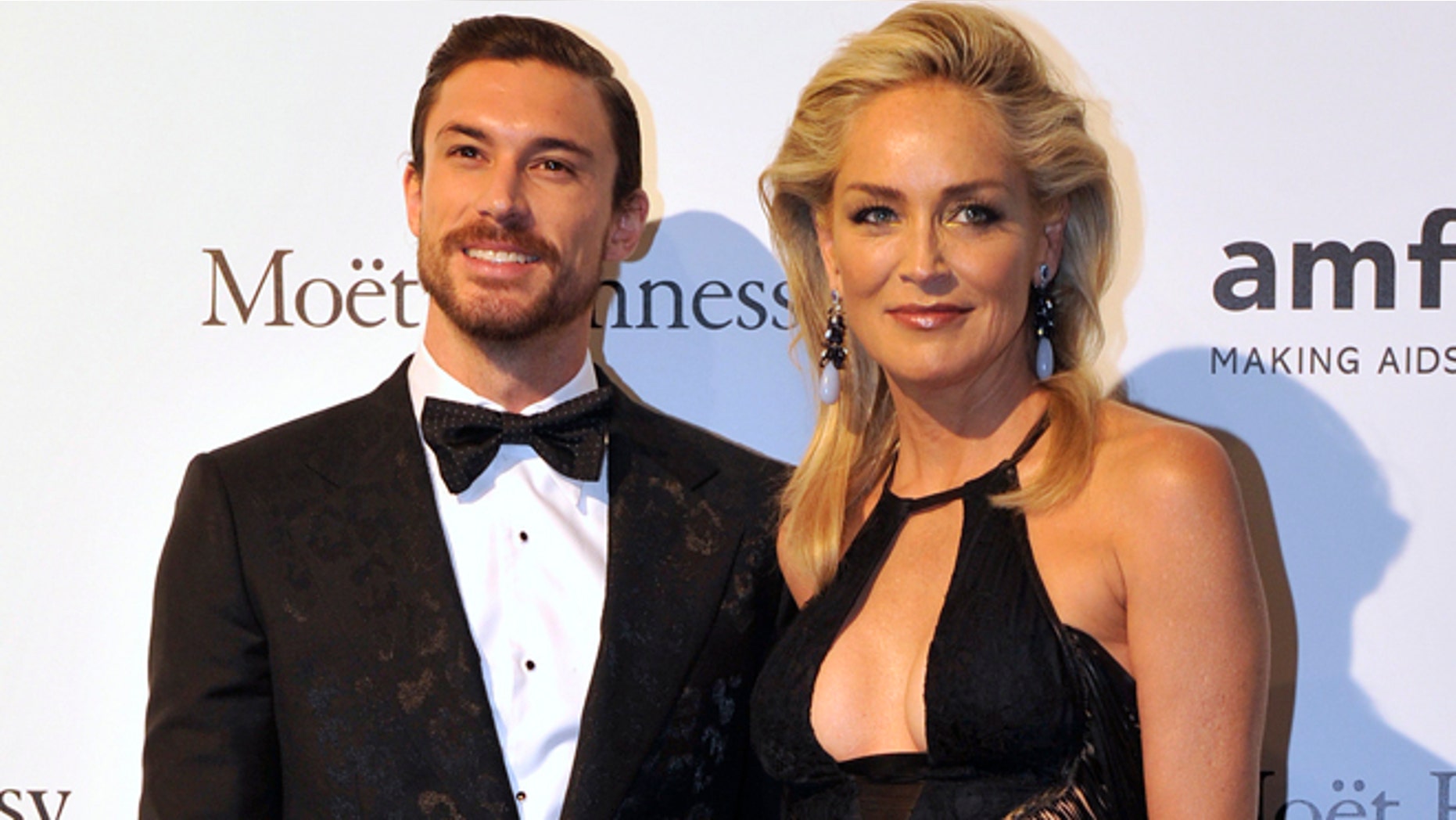Actress Sharon Stone poses with her boyfriend Martin Mica before the charity dinner for The Foundation for AIDS Research (amfAR)'s during Milan's Fashion Week September 22, 2012.