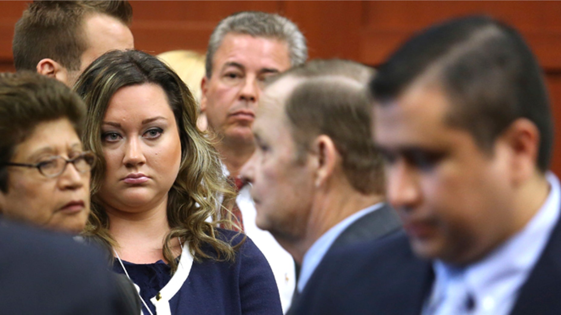 July 12, 2013: George Zimmerman's wife, Shellie, watches her husband leave the courtroom during a recess in his trial at the Seminole circuit court in Sanford, Florida.