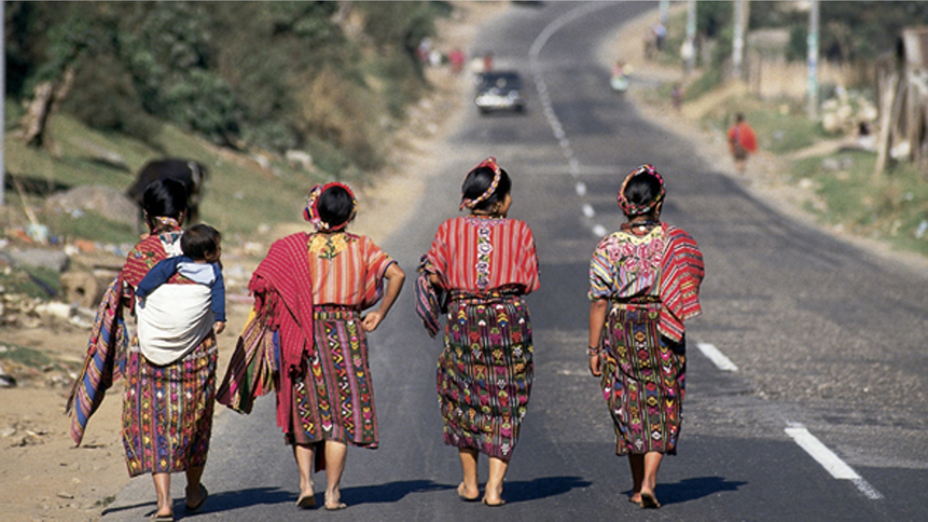 Four Guatemalan women walking down a paved highway near Cantel, Guatemala. (Photo by Independent Picture Service/UIG via Getty Images)
