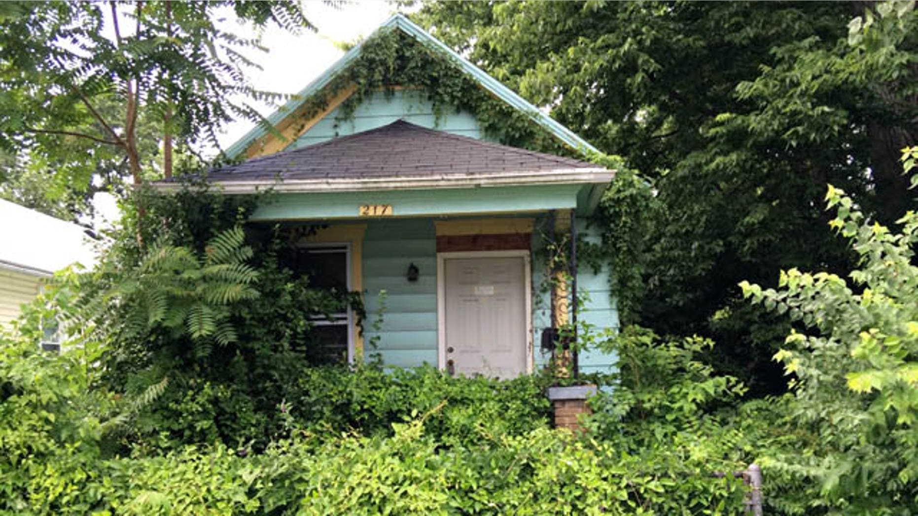 June 16, 2014: This photo shows the vacant house in Dayton, Ohio where an adolescent boy found the mummified body of a man hanging in a closet Sunday. (AP Photo/The Dayton Daily News, Marshall Gorby)