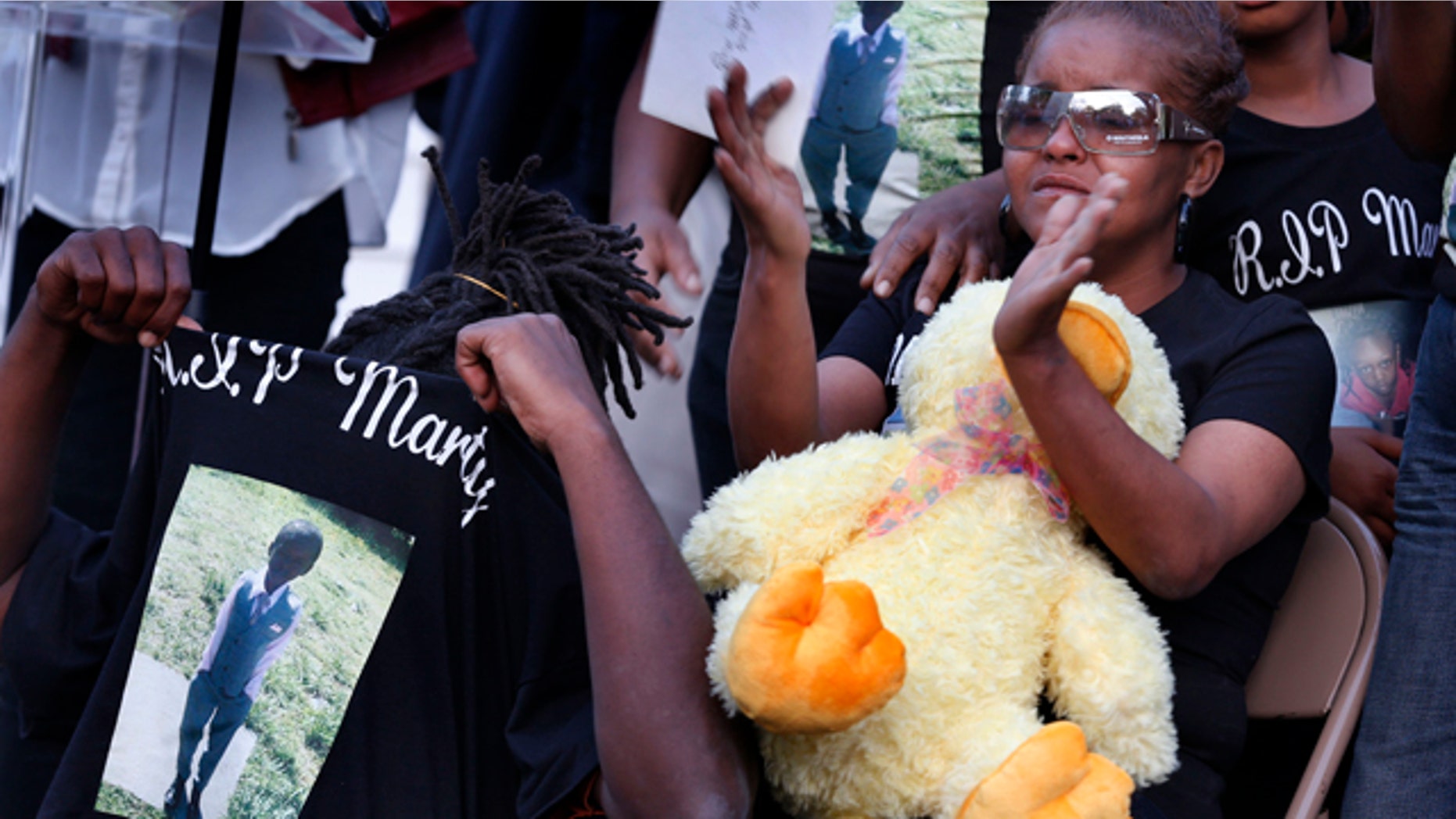 May 3, 2014: Sharain Spruill, mother of Martin Cobb, is surrounded by family during his prayer vigil. A 16-year-old boy was charged Saturday in the assault of a young girl and the killing of her 8-year-old brother, Martin, who was apparently slain when he tried to protect her, authorities and relatives said. (AP Photo/Richmond Times-Dispatch, Dean Hoffmeyer)