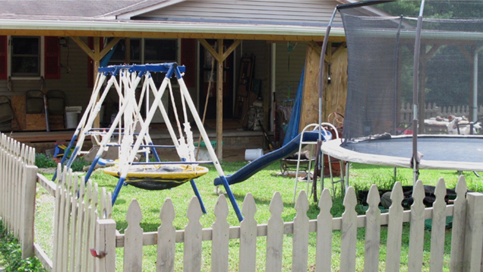 Aug 29, 2013: Playground equipment sits outside the home near London, Ky., where Ernest Chris Chumbley says he fatally shot his wife because she asked him to end her suffering from terminal cancer.