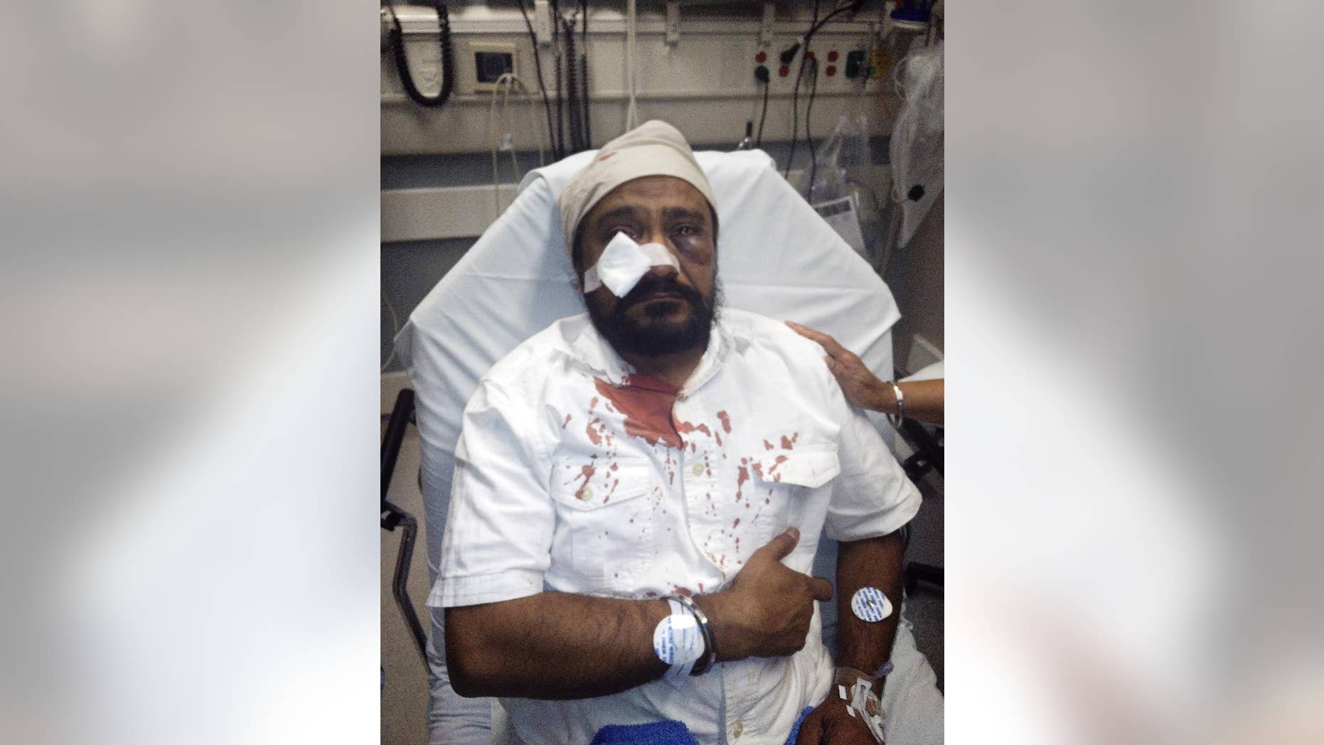 In this Sept. 8, 2015 photo provided by The Sikh Coaliton, 53-year-old Inderjit Mukker is seen at a hospital in Hinsdale, Ill., following an attack authorities say was a road rage incident in Darien, Ill. On Tuesday, Sept. 15, prosecutors said a suburban Chicago teenager who had already been charged with punching the Sikh man has now been charged with a hate crime. (The Sikh Coalition via AP)