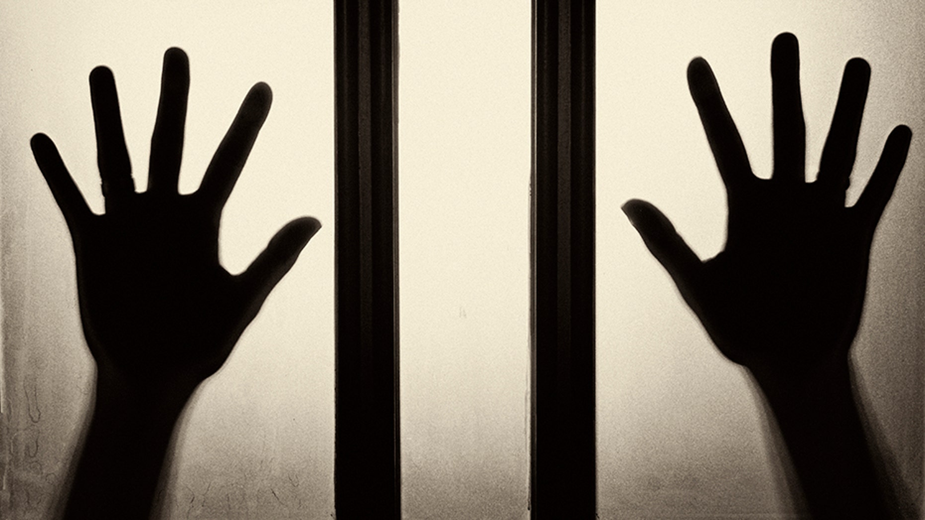 Female hand silhouette on the glass