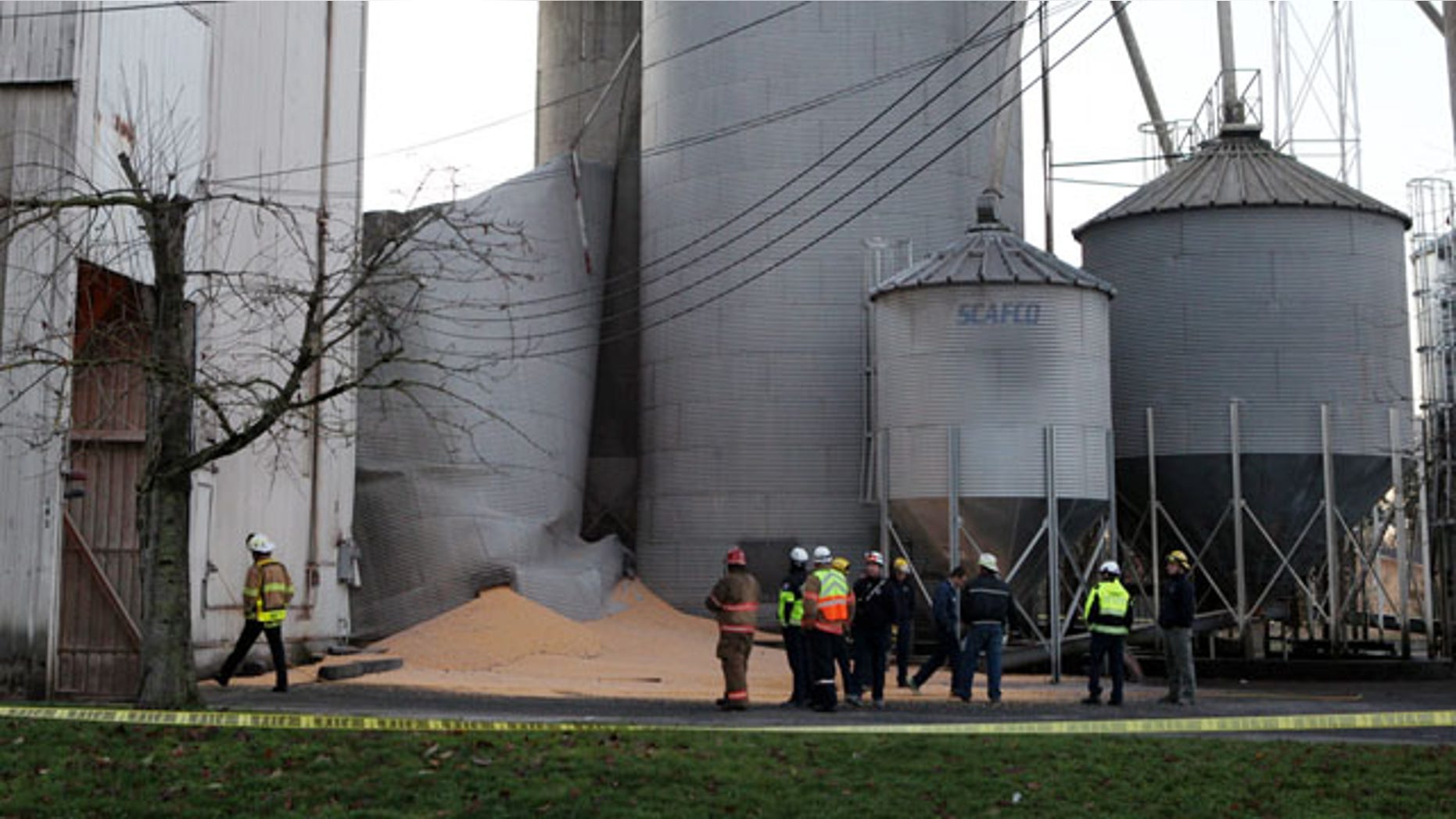 December 2, 2013: Emergency responders from the South Pierce Fire Department respond to a grain processing feed mill owned by Wilcox Farms in downtown Roy, Wash., after one of its silos collapsed. (AP Photo/The Olympian)