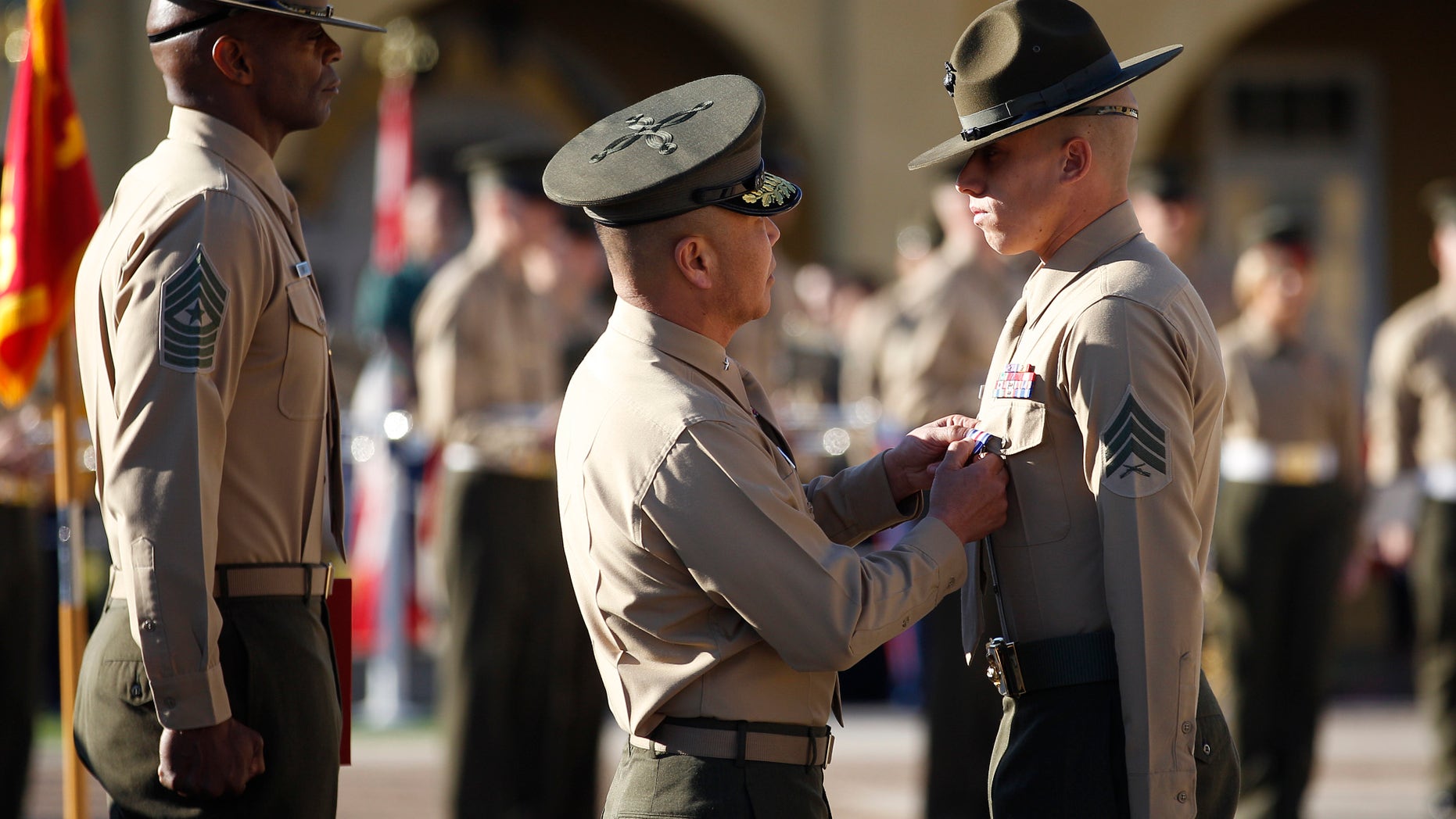 Feb. 10, 2012: United States Marine Sgt. Philip A. McCulloch Jr., right, receives the Silver Star medal from Brigadier General Daniel D. Yoo for "conspicuous gallantry and intrepidity in action" while serving in Afghanistan during a ceremony at the Marine Corp Recruit Depot.