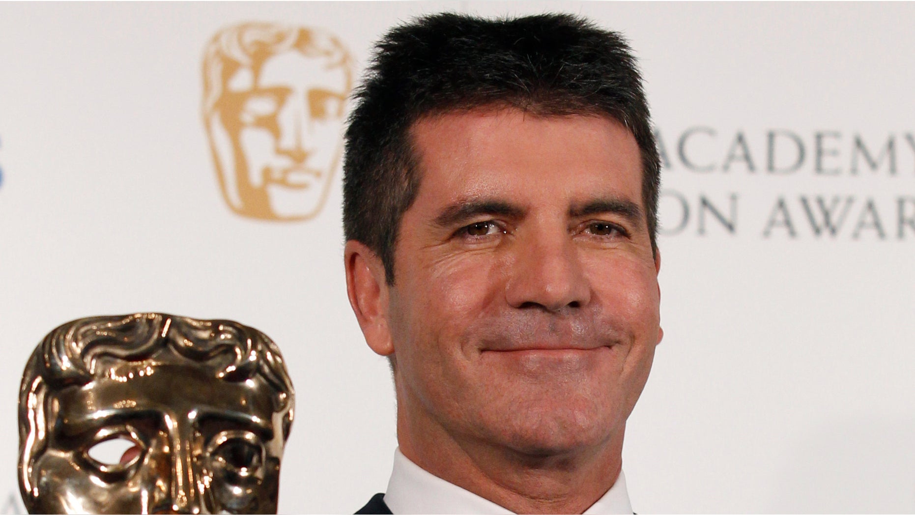 June 6: Television mogul Simon Cowell poses after receiving the British Academy Television Awards Special Award at the Palladium Theatre in London.