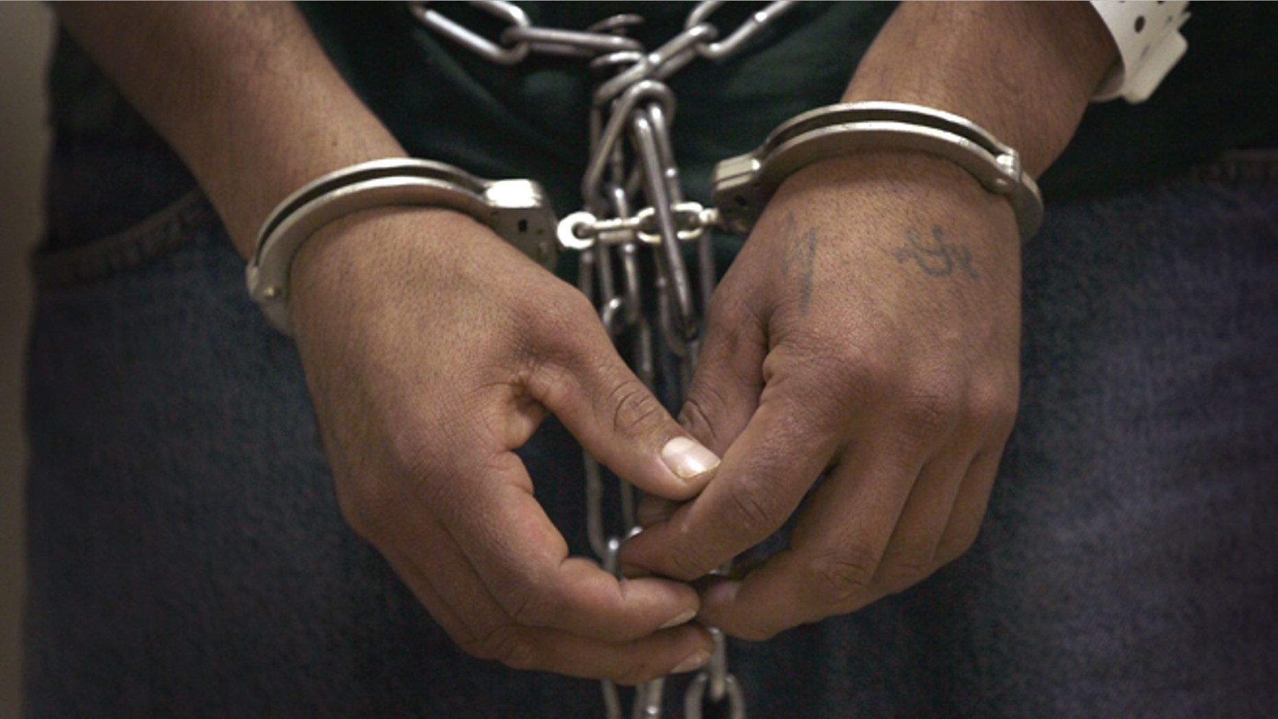 BROADVIEW, IL - MAY 25: An undocumented immigrant stands cuffed and shackled at the U.S. Immigration and Customs Enforcement (ICE) processing facility before he and other undocumented immigrants were transported to the airport for a deportation flight May 25, 2010 in Broadview, Illinois. The immigrants at the suburban Chicago facility were flown by charter flight to Harlingen, Texas where they were then bussed to Brownsville and finally walked to the Mexican border and released from custody. The U.S. deports over 350,000 immigrants a year for entering the country illegally, most are Mexican, and more than 90 percent are men. (Photo by Scott Olson/Getty Images)