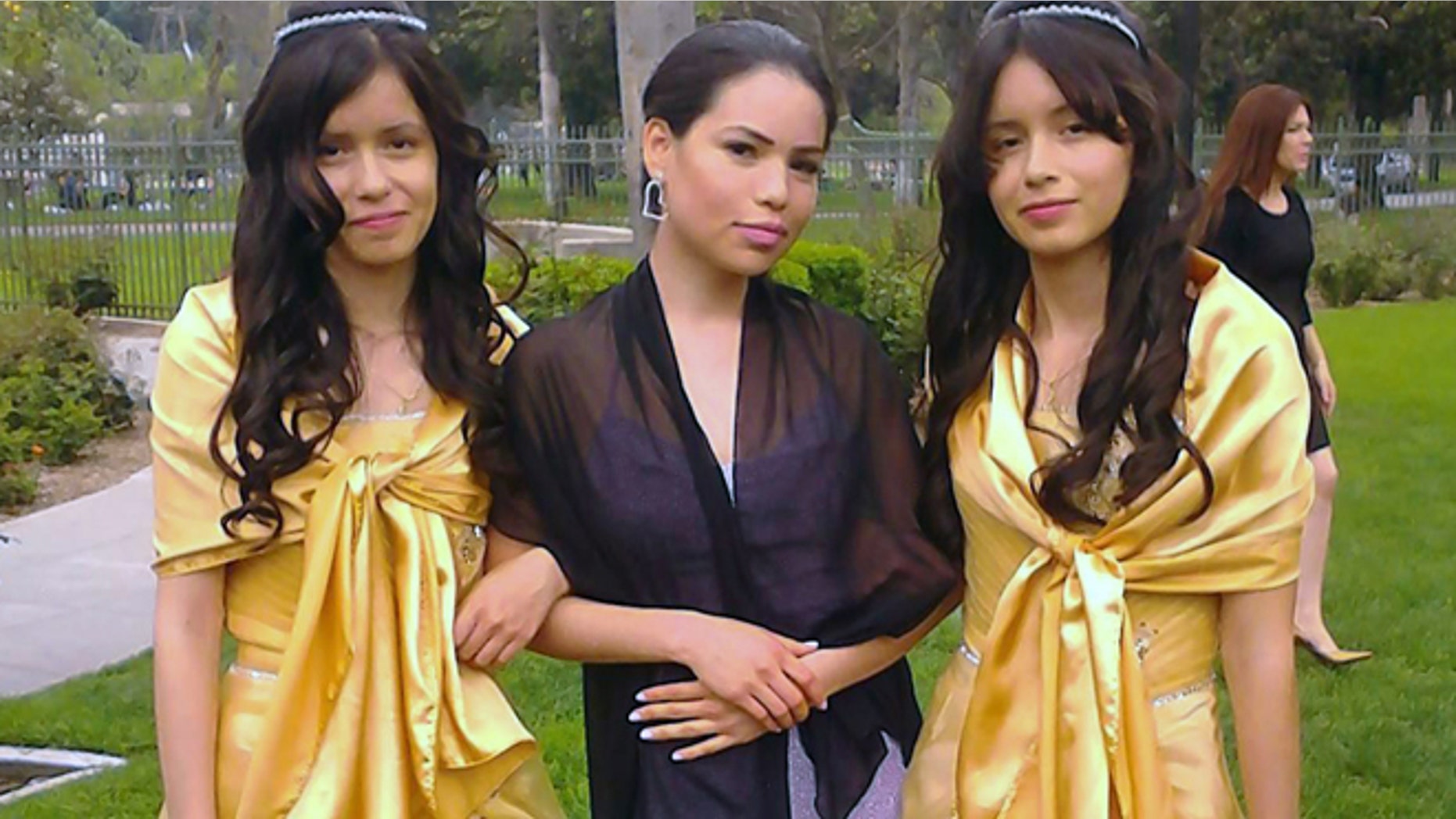 This 2013 photo provided by Miguel Serrato shows twin sisters Marisol Serrato, 17, left, and Marisa Serrato, right, with their sister-in-law Ivette Serrato during a wedding in Riverside, Caif. The twins were part of the group more than 40 high school students whose trip to visit a college turned tragic when a FedEx tractor-trailer veered across a grassy highway median and slammed into their bus in a wreck that left 10 people dead, authorities said. Marisa was one of the twins on the bus that crashed but is still unaccounted for. Marisol was on another bus that wasn't in the accident. (AP Photo/Courtesy Miguel Serrato)