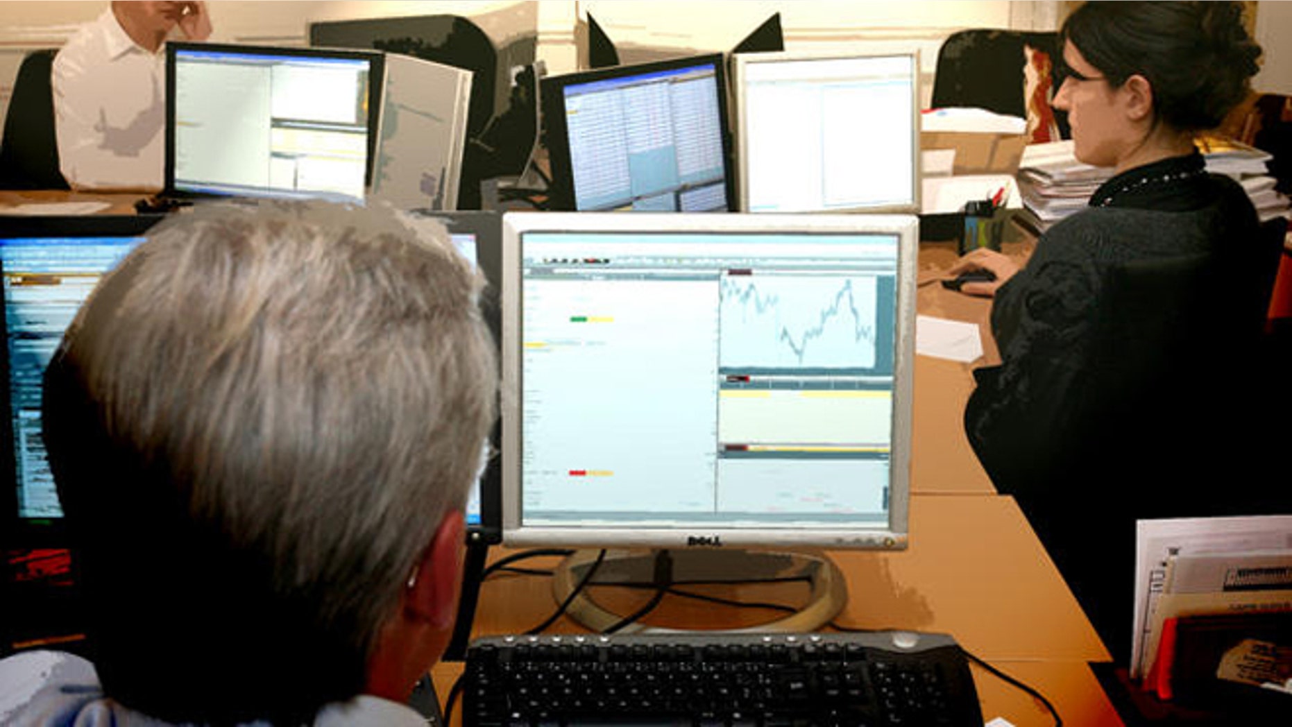 Employees of Montsegur Finance, a portfolio management company authorized by the Financial Markets Authority, work at their desk in Paris, Monday, Jan. 21, 2008. France's stock markets plunged on Monday following declines on Wall Street last week amid investor pessimism over the US government's stimulus plan to prevent a recession. France's CAC 40 slid 6.1 percent, but it was not the only European country to see a significant drop. Germany's DAX was down 6 percent in morning trading, while Britain's FTSE 100 dropped 5.1 percent. (AP Photo/Thibault Camus)