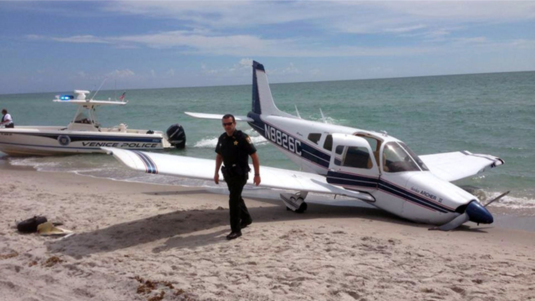 July 27, 2014: This photo provided by the Sarasota County Sheriff's Office shows emergency personnel at the scene of a small plane crash in Caspersen Beach in Venice, Fla. Authorities say a father was killed and his daughter seriously injured while walking on the sand when a small plane crash landed along Florida's Gulf Coast near Venice Beach. (AP Photo/Sarasota County Sheriff's Office)
