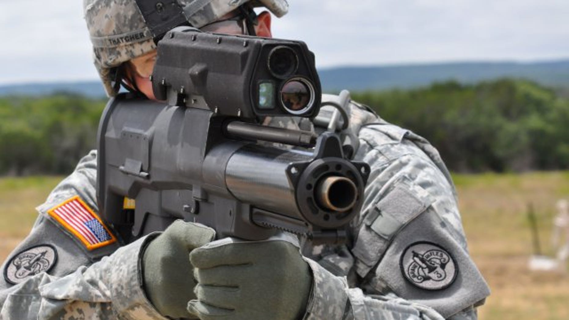 File photo - a soldier aims an XM25 Counter Defilade Target Engagement weapon system at Aberdeen Test Center, Md.