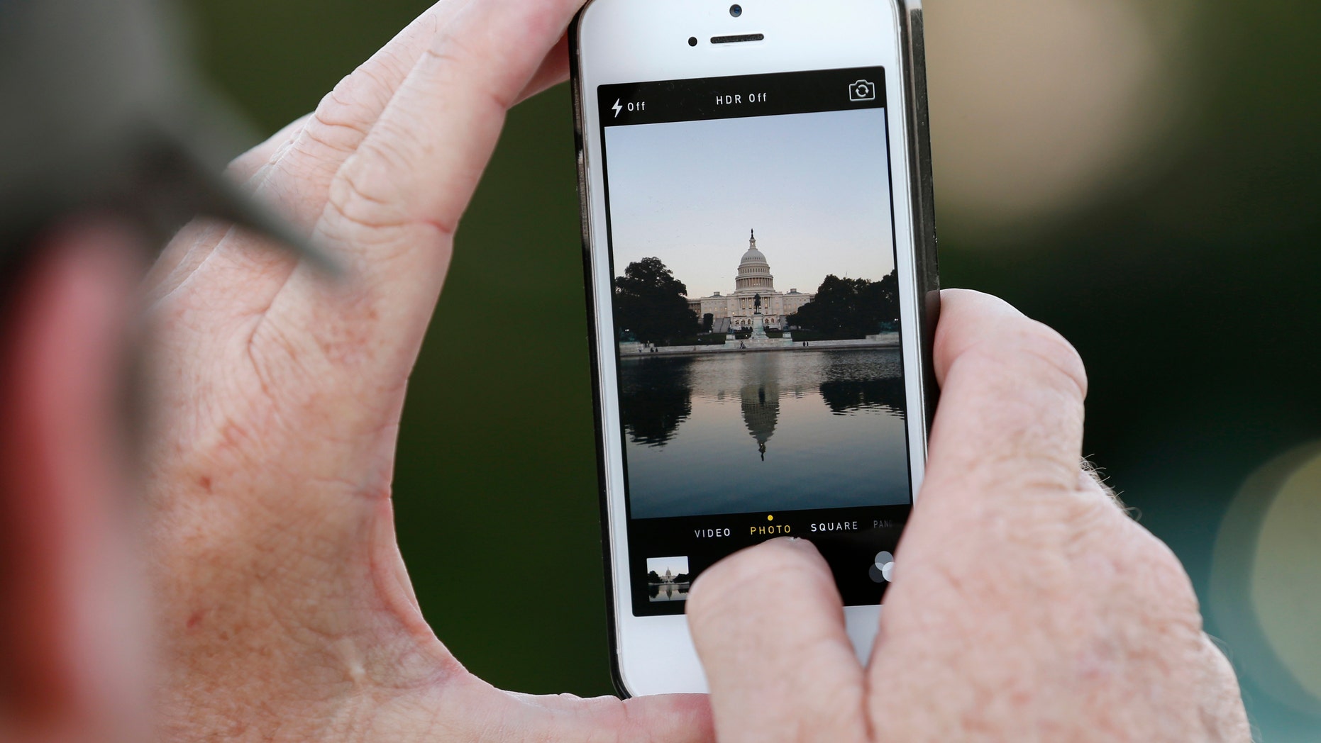 A man takes a photo of the U.S. Capitol, on the eve of a potential federal government shutdown, in Washington September 30, 2013. As many as a million government employees were making urgent plans on Monday for a possible midnight shutdown, with their unions urging Congress to strike a last-minute deal.
REUTERS/Kevin Lamarque (UNITED STATES - Tags: POLITICS BUSINESS) - RTR3FGGG