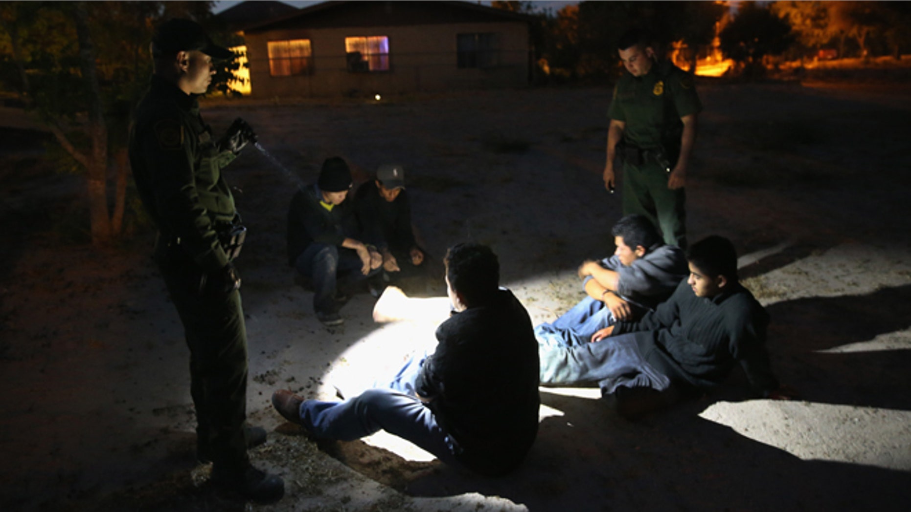 MISSION, TX - APRIL 11: U.S. Border Patrol agents detain undocumented immigrants who had crossed from Mexico into the United States on April 11, 2013 in Mission, Texas. In the last month the Border Patrol's Rio Grande Valley sector has seen a spike in the number of immigrants crossing the river from Mexico into Texas. With more apprehensions, they have struggled to deal with overcrowding while undocumented immigrants are processed for deportation. According to the Border Patrol, undocumented immigrant crossings have increased more than 50 percent in Texas' Rio Grande Valley sector in the last year. Border Patrol agents say they have also seen an additional surge in immigrant traffic since immigration reform negotiations began this year in Washington D.C. Proposed refoms could provide a path to citizenship for many of the estimated 11 million undocumented workers living in the United States. (Photo by John Moore/Getty Images)