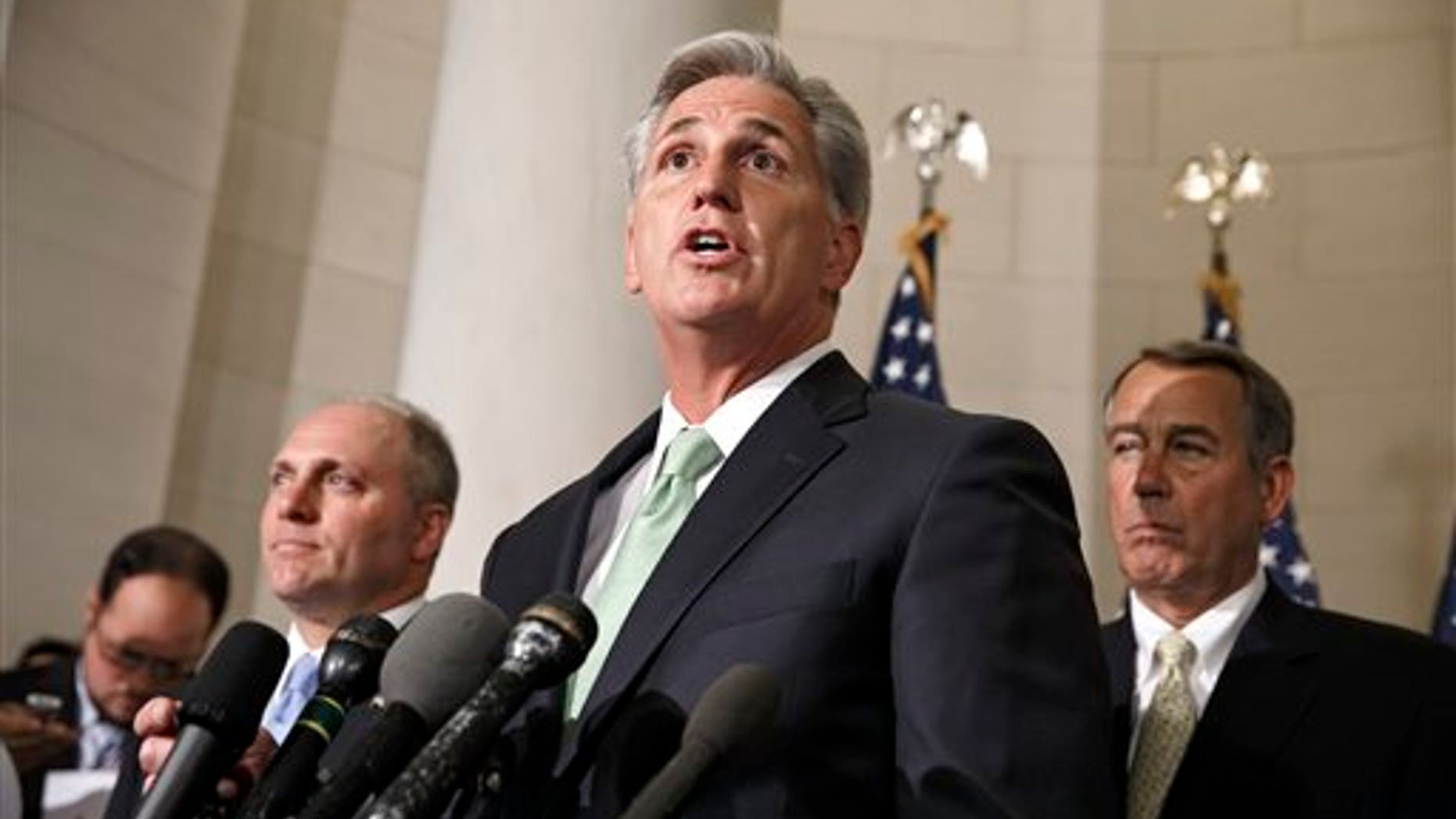 FILE - This June 19, 2014 file photo shows House Majority Whip Kevin McCarthy, R-Calif., with Rep. Steve Scalise, R-La., left, and Speaker of the House John Boehner, R-Ohio, right, on Capitol Hill in Washington just after McCarthy was voted new majority leader, replacing Rep. Eric Cantor, R-Va., who was defeated in the primary election. (AP Photo/J. Scott Applewhite, File)