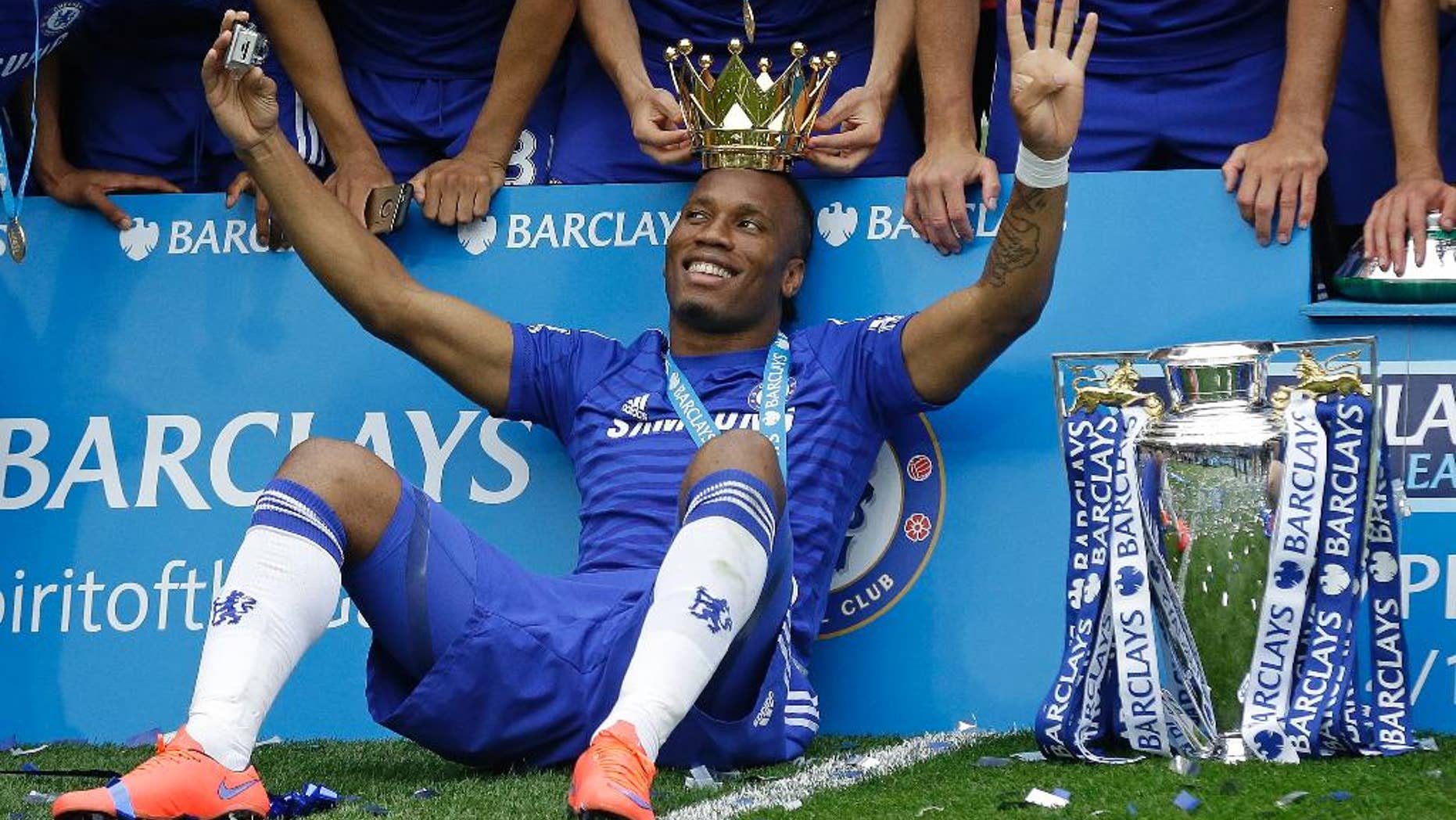 FILE - In this Sunday, May 24, 2015 file photo, the crown of the trophy is placed on the head of Didier Drogba after the English Premier League soccer match between Chelsea and Sunderland at Stamford Bridge stadium in London. Montreal Impact says it has signed former Chelsea striker Didier Drogba. Impact confirmed the signing on Monday, July 27, 2015 following a trade with Chicago Fire, which had initially completed a move for the 37-year-old forward. (AP Photo/Matt Dunham, File)