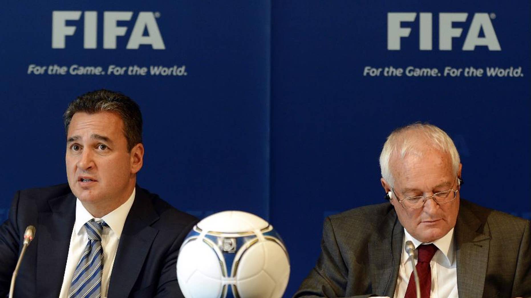 FILE - In this Friday, July 27, 2012 file photo, Chairmen of the two chambers of the new FIFA Ethics Committee Michael Garcia, left, from the US and Joachim Eckert, right, from Germany attend a press conference, at the Home of FIFA in Zurich, Switzerland. FIFA ethics judge Joachim Eckert is unlikely to reach final decisions in the 2018 and 2022 World Cup bidding corruption probe until early next year. The German judge also suggested on Friday, Sept. 19, 2014, it was not his job to remove Russia or Qatar as hosts or order a re-vote based on FIFA prosecutor Michael Garcia's investigation. (AP Photo/Keystone, Walter Bieri, File)