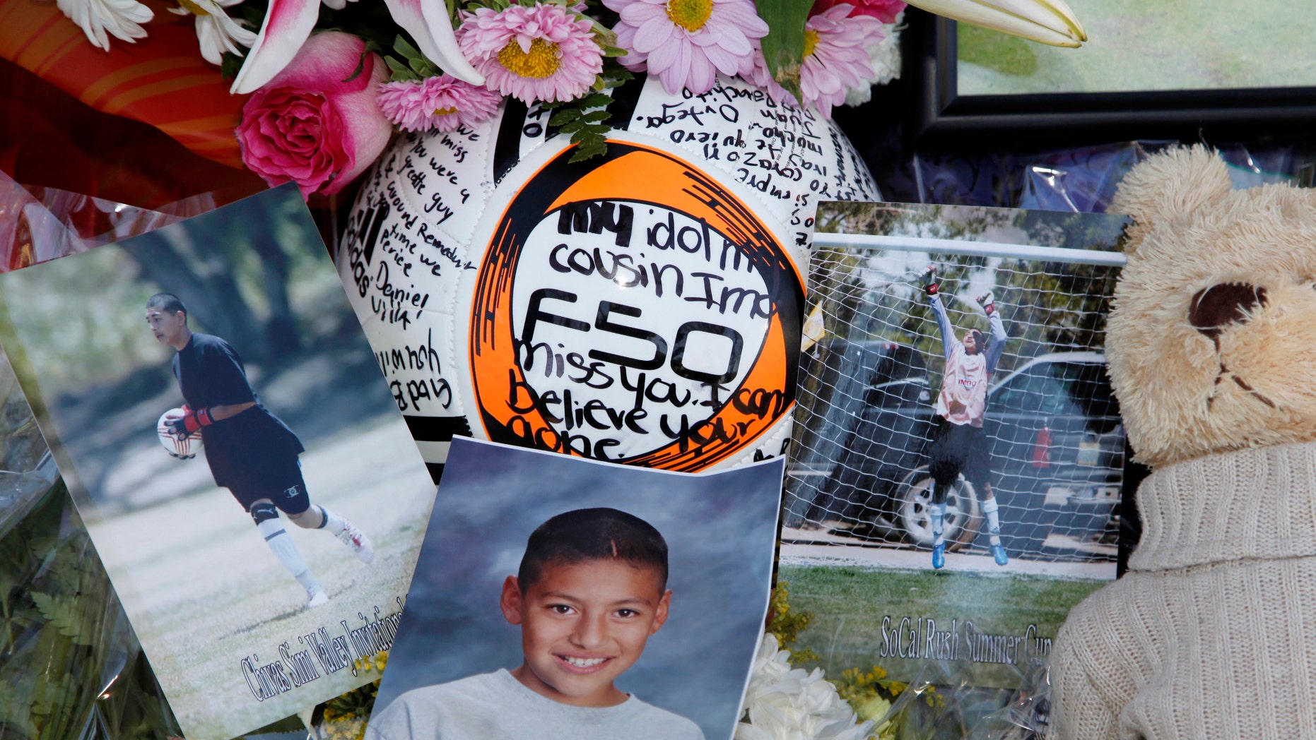 Photos of El Camino Real's goalkeeper Francisco Rodriguez, are seen next to a soccer ball at a memorial set outside his family's home in Los Angeles.