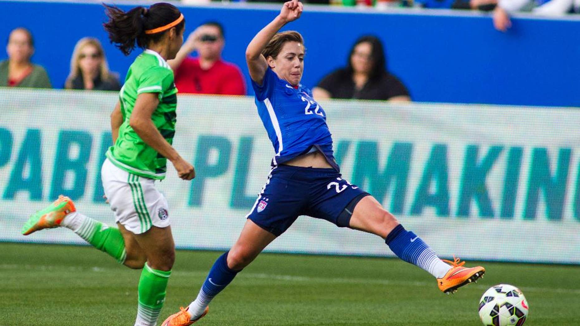 FILE - In this May 17, 2015 file photo, United States’ defender Meghan Klingenberg, right, tries to control a ball against Mexico's defender Kenti Robles during the first half of their friendly soccer match, in Carson, Calif. With each match the Americans play and through every rigorous training session, Klingenberg and the defense become more comfortable together on a new-look back line ahead of their World Cup opener 2 1/2 weeks from now against Australia in Winnipeg. (AP Photo/Ringo H.W. Chiu, File)