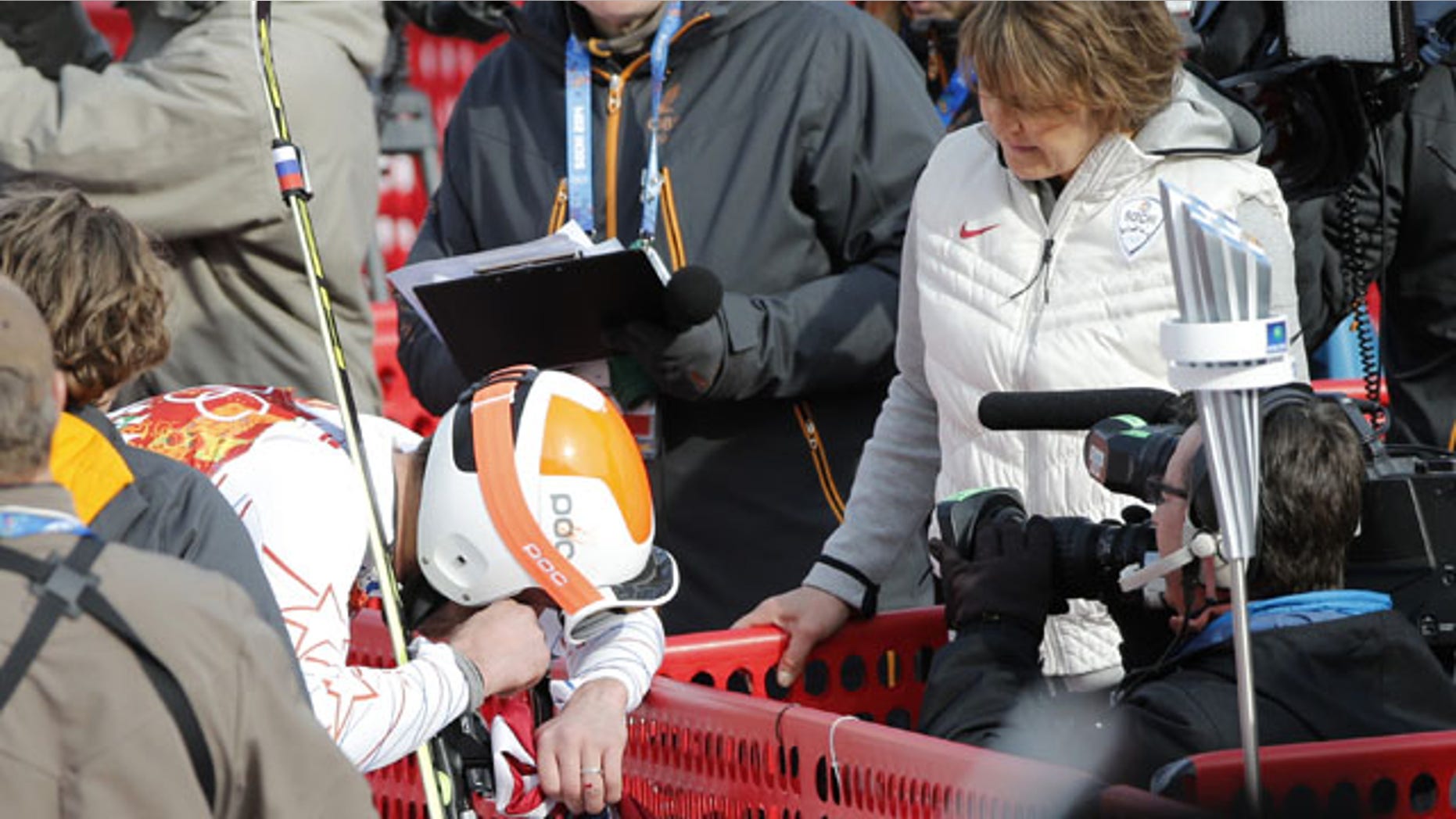 February 16, 2014: Men's super-G joint bronze medal winner Bode Miller of the United States breaks down in tears during an interview with NBC reporter Christin Cooper (in white jacket) at the Sochi 2014 Winter Olympics in Krasnaya Polyana, Russia. (AP Photo/Christophe Ena)