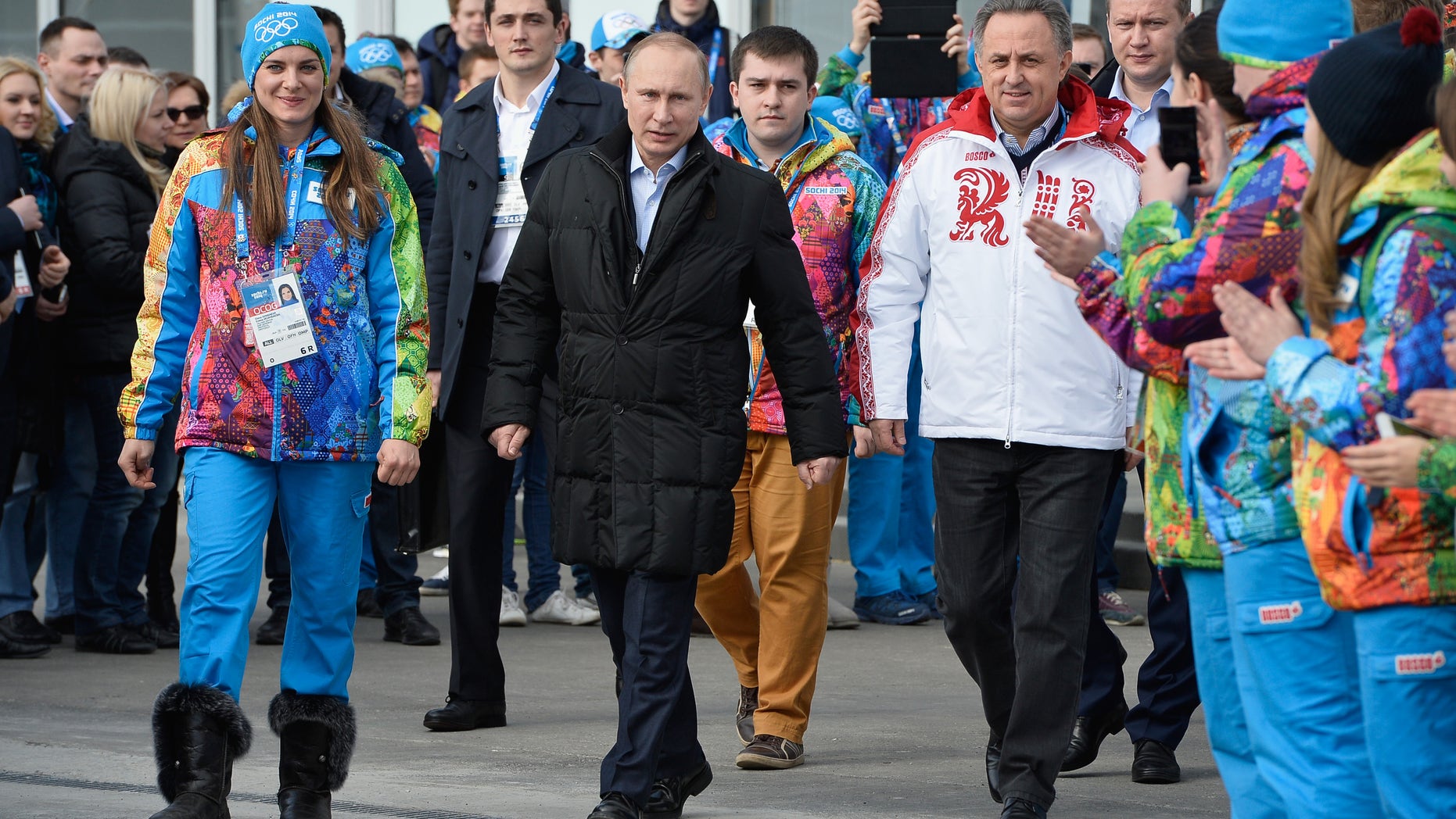 Feb. 5, 2014: Russian President Vladimir Putin, center, visits the Olympic Athletes Village in Coastal Cluster ahead of the Sochi 2014 Winter Olympics with Olympic Village Mayor Elena Isinbaeva, left, and Russian Minister of Sport, Tourism and Youth policy Vitaly Mutko in Sochi, Russia.