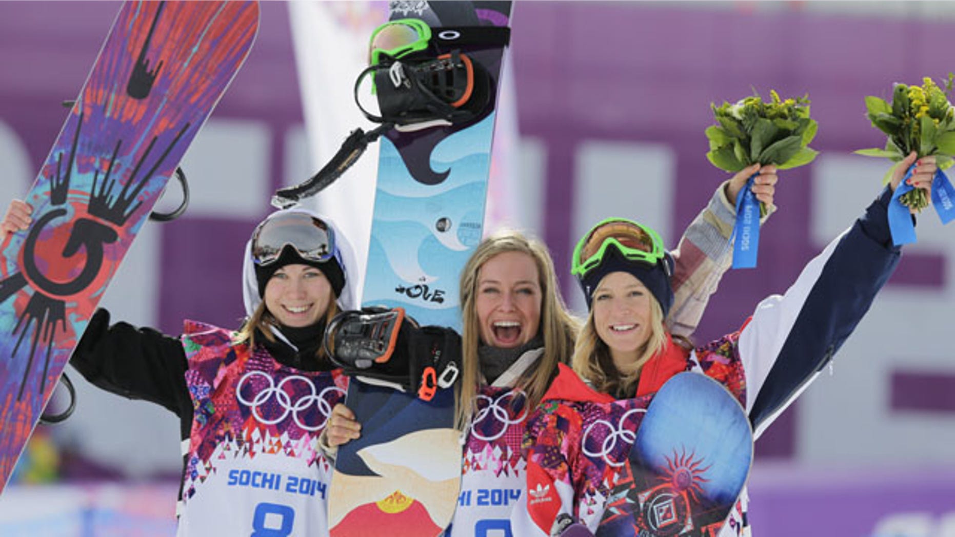 February 9, 2014: Jamie Anderson of the United States, center, celebrates with silver medalist Enni Rukajarvi of Finland, left, and bronze medalist Jenny Jones of Britain, after Anderson won the women's snowboard slopestyle final at the 2014 Winter Olympics in Krasnaya Polyana, Russia. (AP Photo/Andy Wong)