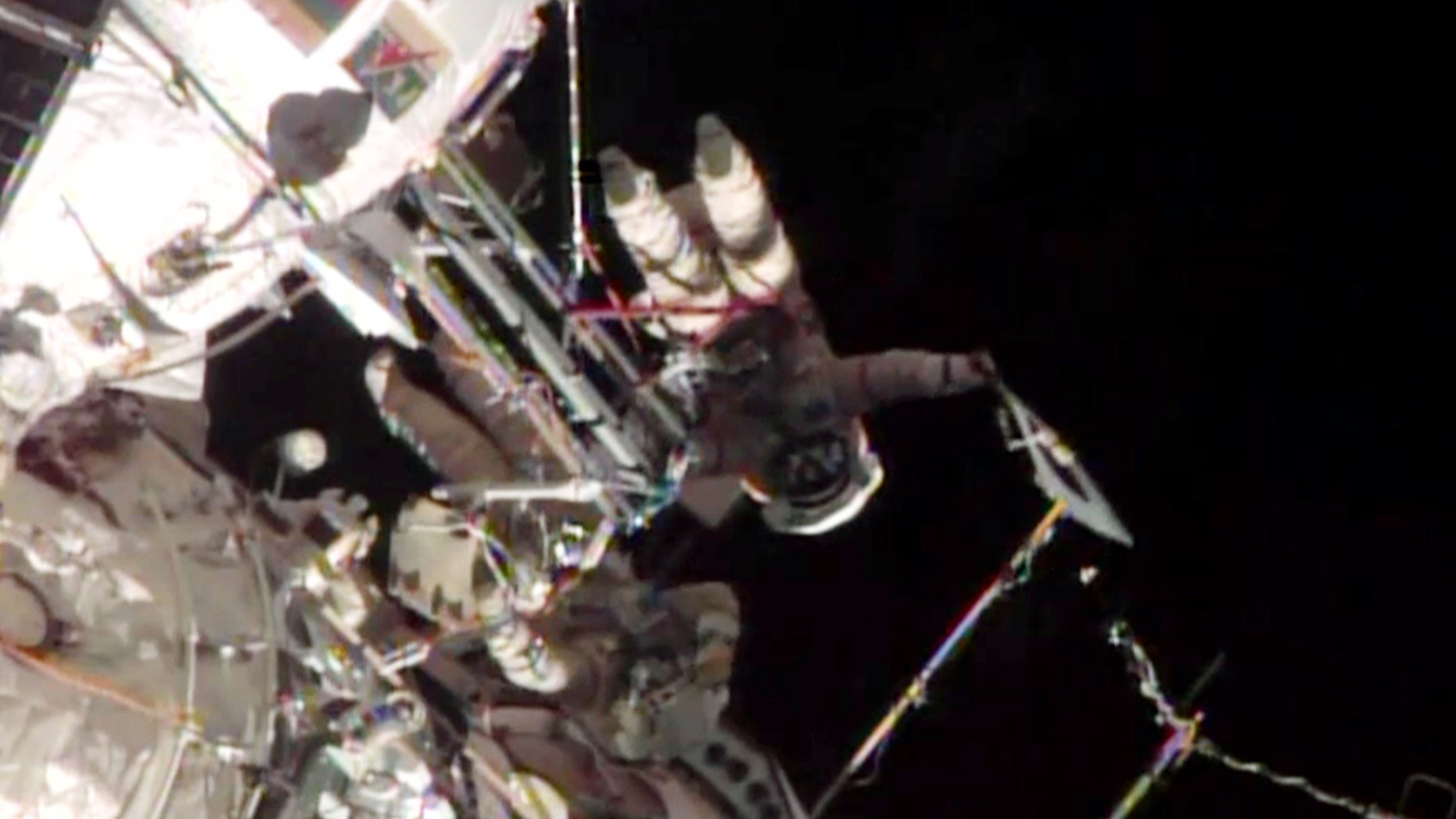 Nov. 9, 2013: This screen image taken from NASA shows the Sochi Olympic torch being held during a spacewalk.