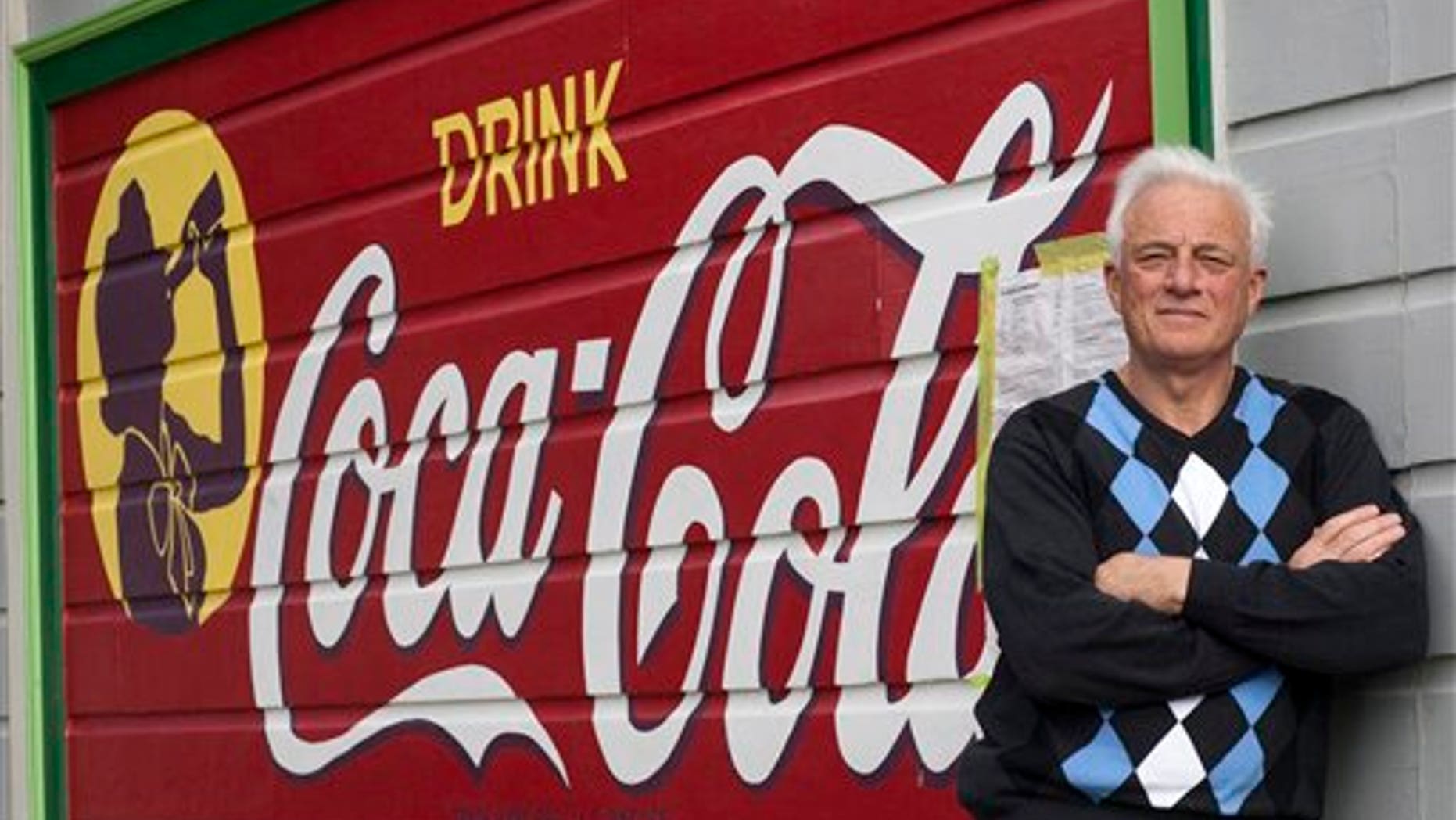 Feb. 23: Richard Modolo stands in front of a Coca-Cola sign that was painted on the side of his house decades ago when his home was the site of a mom-and-pop grocery store, in San Francisco. City officials say the painted sign in the Bernal Heights neighborhood violates anti-billboard laws and must come down. (AP/San Francisco Chronicle)