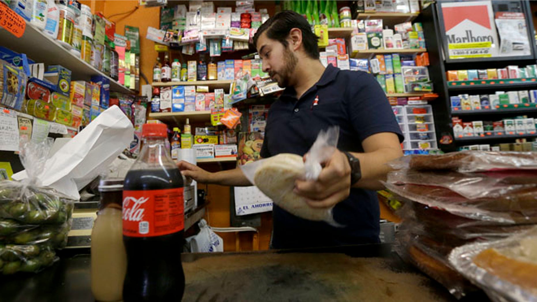Alex Del Rio works at his family's market El Ahorro in San Francisco, Wednesday, Sept. 21, 2016.