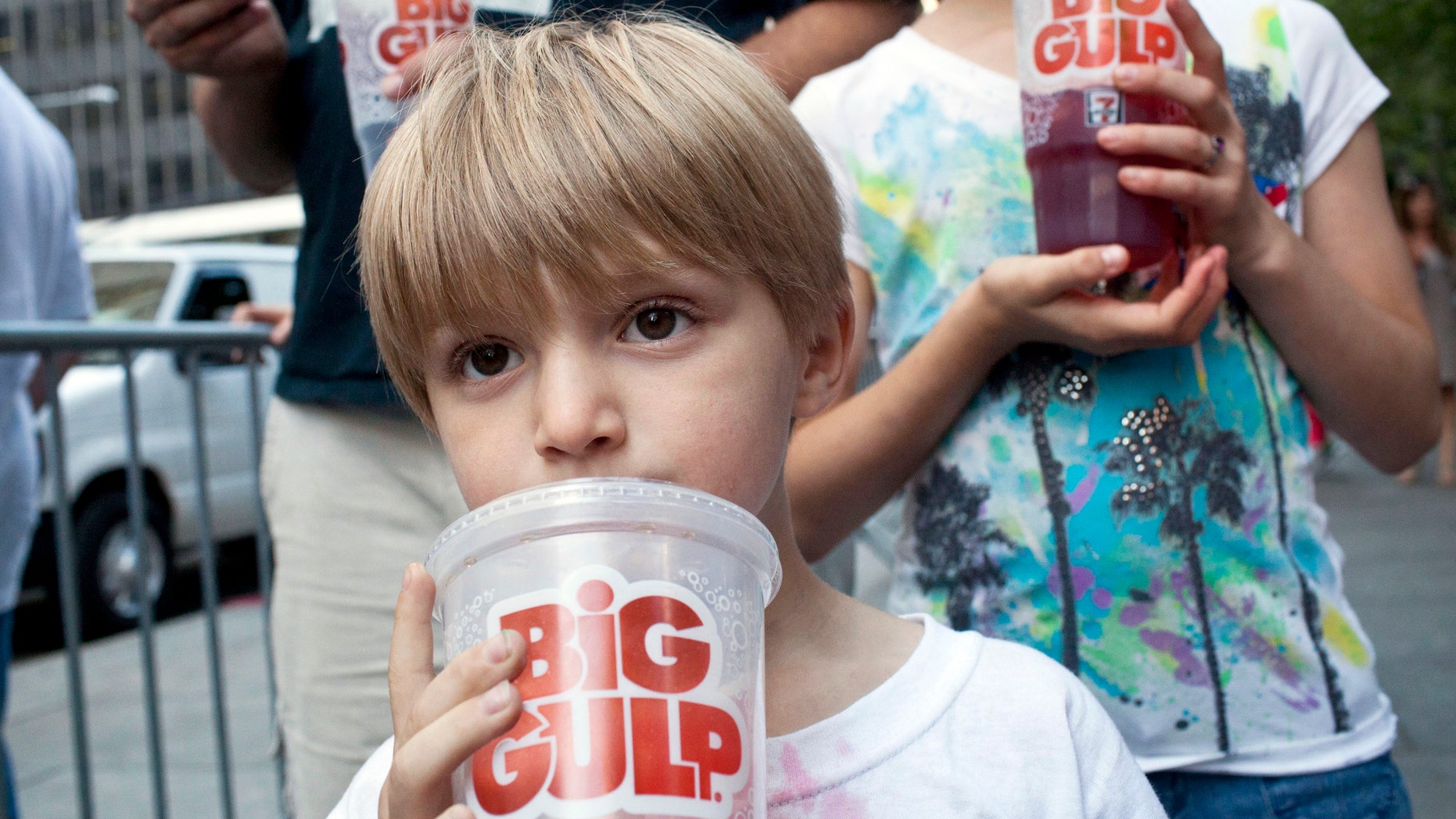 Benjamin Lesczynski, 8, of New York, takes a sip of a "Big Gulp" while protesting the proposed "soda-ban" that New York City Mayor Michael R. Bloomberg suggested, outside City Hall in New York July 9, 2012.