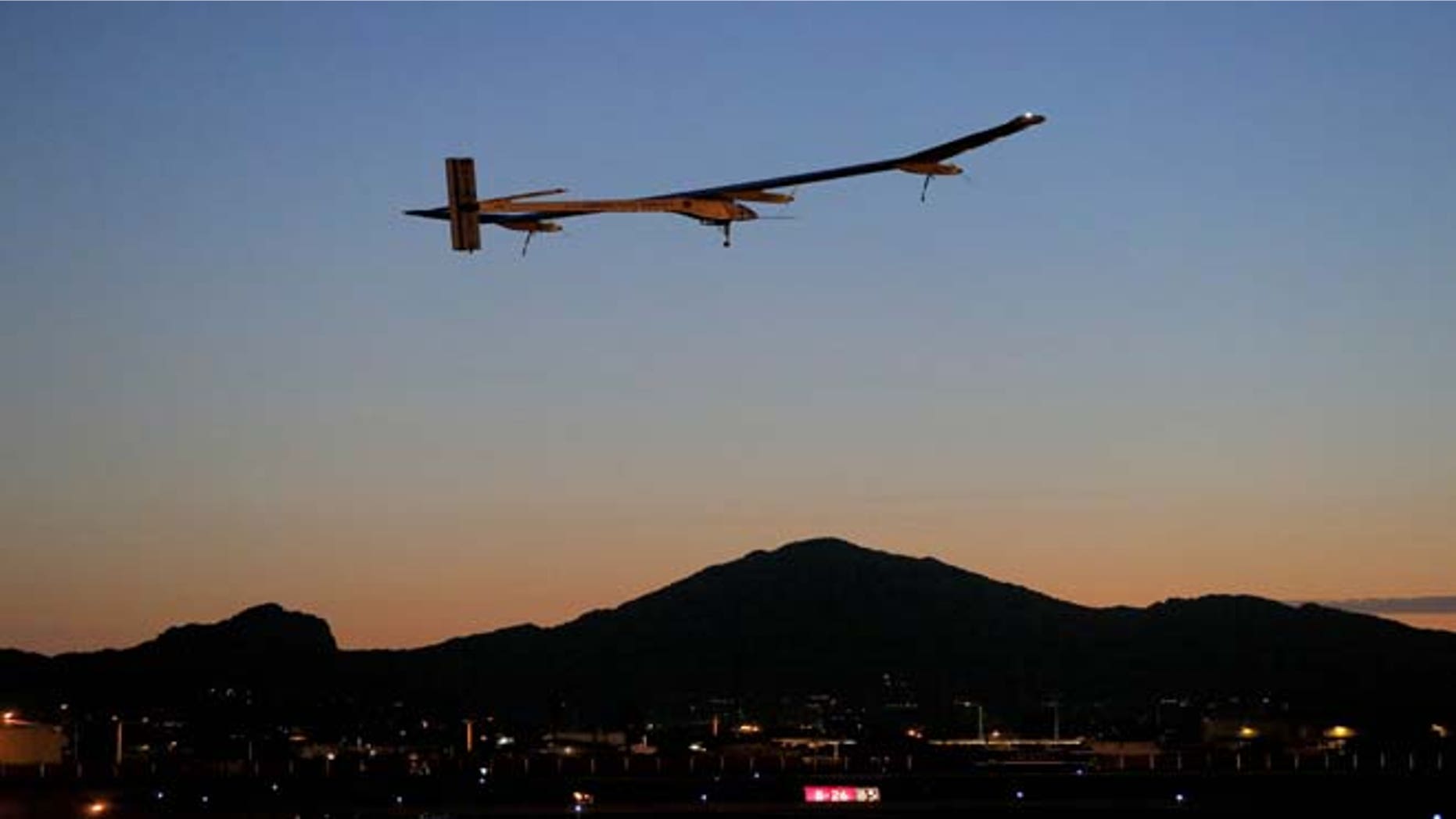 FILE - This May 22, 2013 file photo shows the Solar Impulse, piloted by André Borschberg, taking flight, at dawn, from Sky Harbor International Airport in Phoenix. The spindly no-fuel plane called Solar Impulse is scheduled to leave Washington Saturday early in the morning and arrive after midnight at New York's John F. Kennedy International Airport. It may silently buzz the Statue of Liberty on the way. The plane started its cross-country journey May 3 from San Francisco.