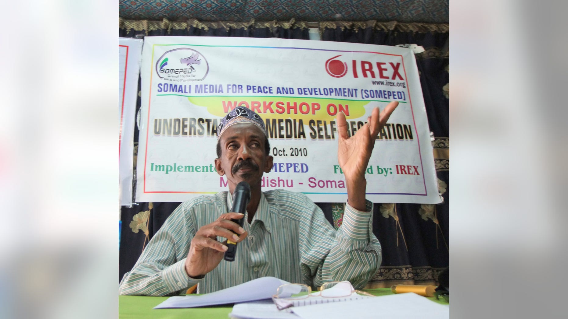 in this photo taken Thursday Oct, 14, 2010, veteran reporter Yusuf Ali Osman who has been serving as a director in Somalia's Ministry of Information, speaks during a meeting by Somali journalists in Mogadishu, Somalia. Yusuf Ali Osman, together with another journalist, has been killed, it is reported Monday Aug. 13, 2012, in separate incidents in the Somali capital Mogadishu. Bashir Khalif Ghani of Radio Mogadishu said Monday that a man dressed as a high school student shot and killed Yusuf Ali Osman as he walked to work on Sunday. Somalia's information minister confirmed the killing and said in a statement that the government was appalled by the murder of Osman. (AP Photo/Farah Abdi Warsameh)