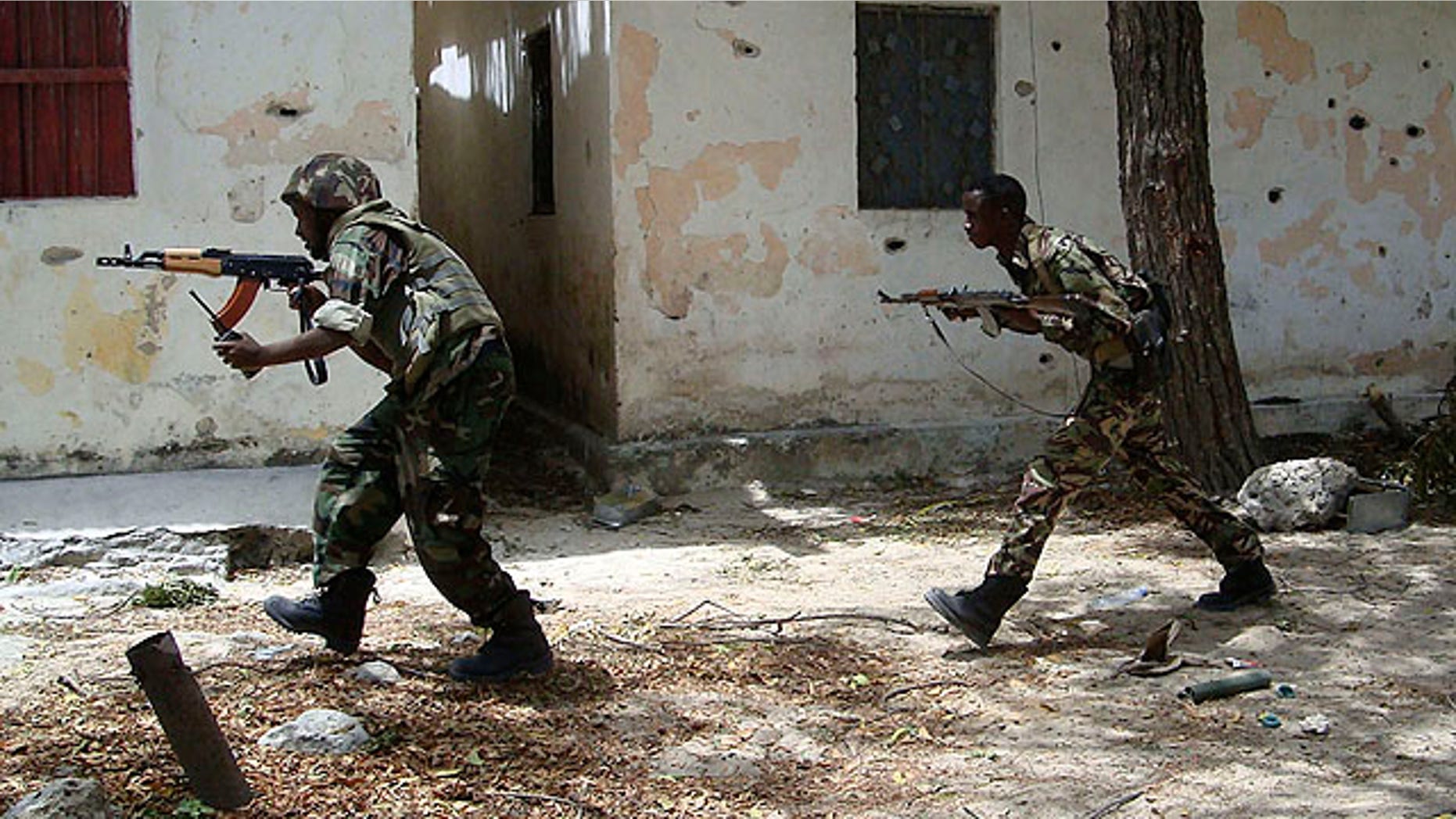 Sept. 27, 2010: Somali government forces run in a street during skirmishes with insurgents from the al-Qaida aligned terrorist group Al-Shabaab in the Wardigley neighborhood in Mogadishu, Somalia.