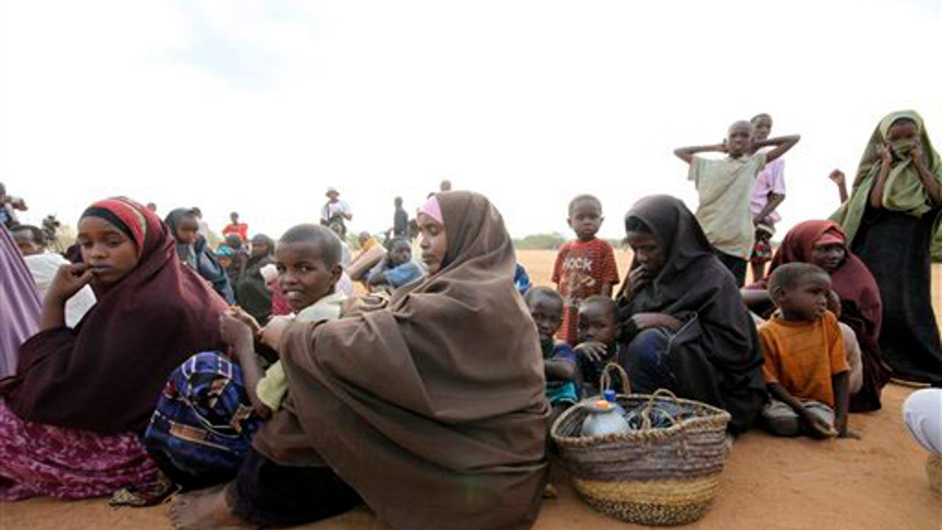 Women and children fleeing the war in Somalia queue to register at Dadaab, the refugee camp in northern Kenya, Thursday, Sept. 9, 2010. Dadaab is already over three times its capacity. It's one of the largest refugee camps in the world with nearly 300,000 inhabitants. Anyone who can afford to flee the intensified fighting in the Somali capital is leaving, refugees said Thursday, and poor families are facing an agonizing choice over who should be saved and who should be left behind. (AP Photo)
