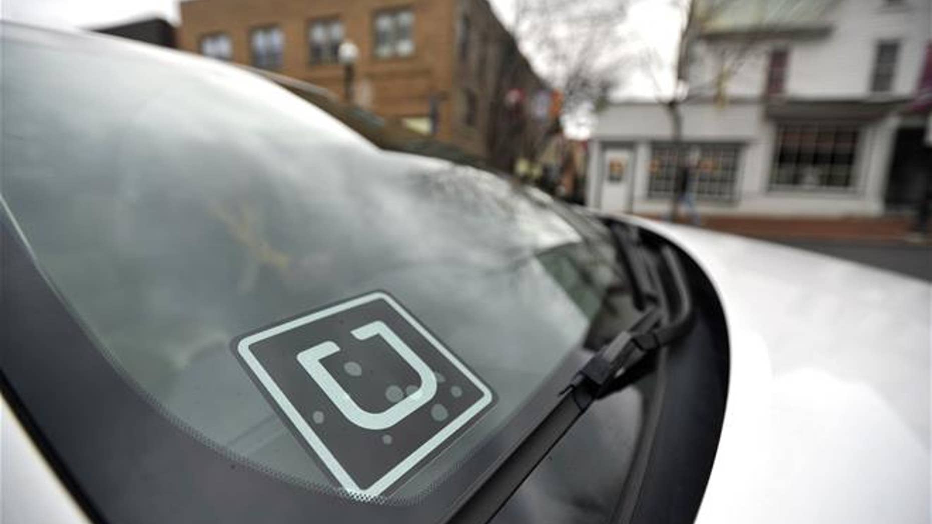 In this photo taken Feb. 25, 2016, an Uber decal is displayed in the their window of the car owned by Steve Linnes, a music teacher in State College, Pa., who is also a part-time Uber driver.