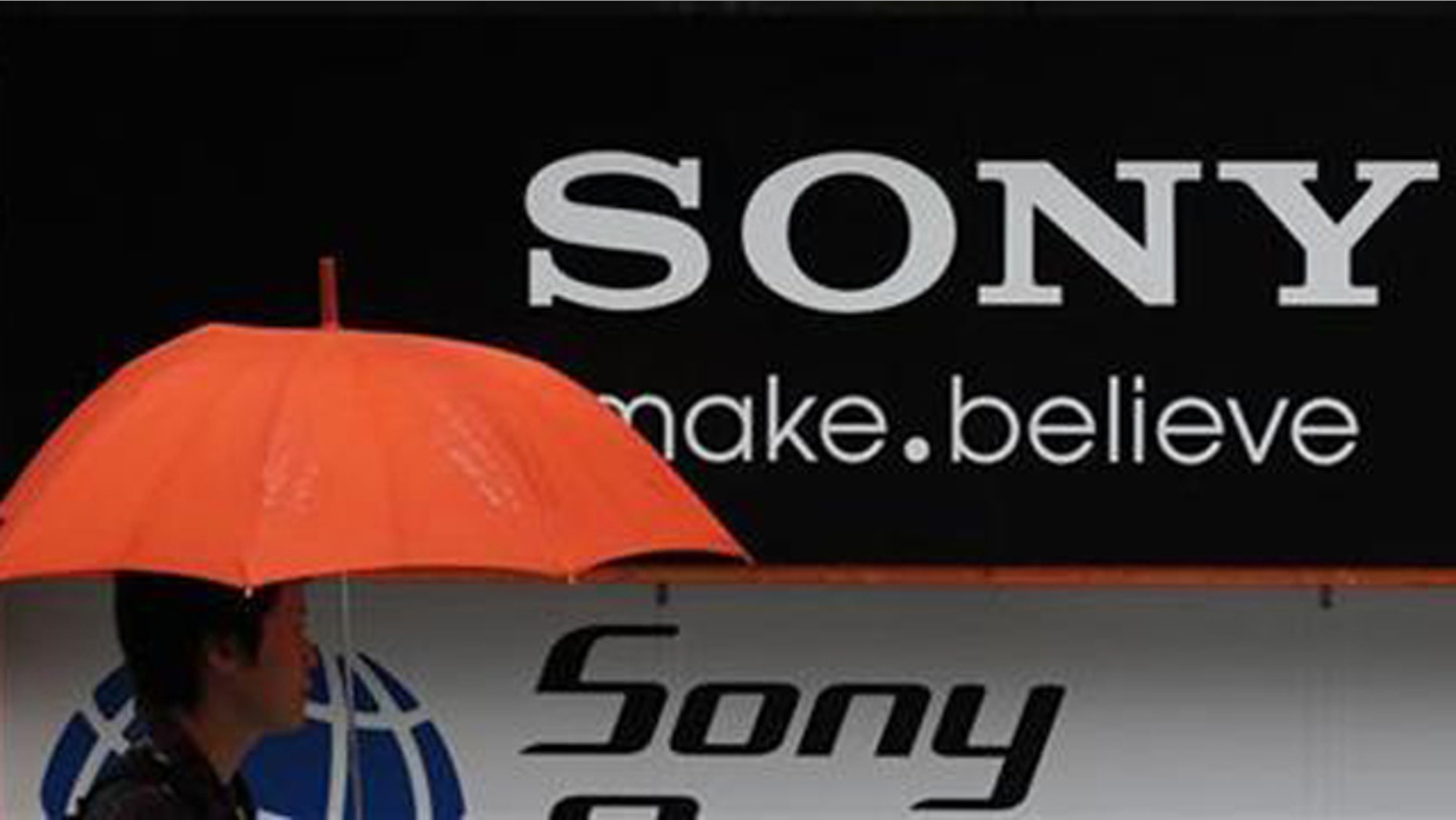 A man walks past a Sony logo in front of an electronic shop in Tokyo May 3, 2011.