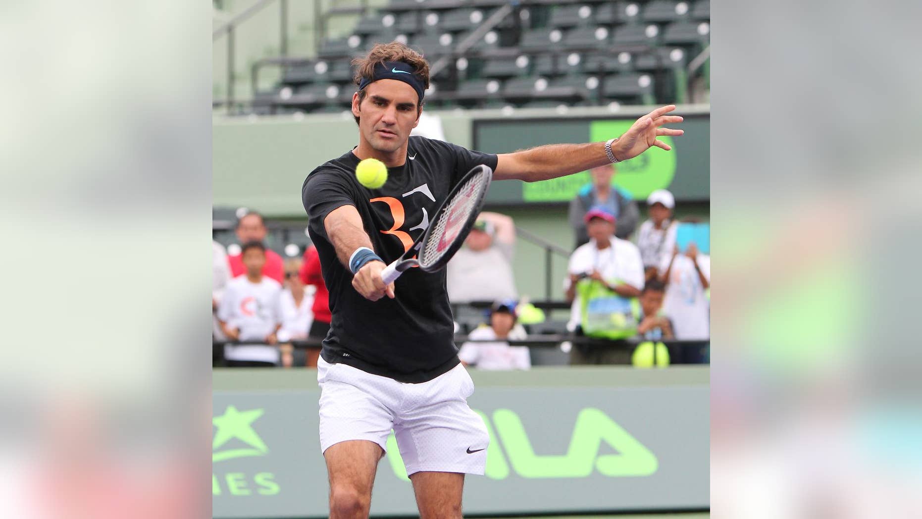 Roger Federer, from Switzerland, returns the ball during practice atthe Sony Open tennis tournament at Crandon Park in Key Biscayne on Tuesday, March 18, 2014. (AP Photo/El Nuevo Herald, David Santiago) MAGS OUT