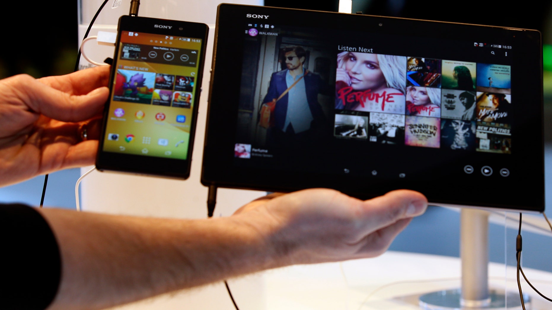 REFILE - CORRECTING GRAMMAR A Sony Xperia Z2 smartphone (L) and a Sony Xperia Z2 tablet are displayed at the company's stand during the Mobile World Congress in Barcelona February 24, 2014. The congress is the wireless industry's largest annual conference and runs February 24-27, 2014. REUTERS/Gustau Nacarino (SPAIN - Tags: BUSINESS TELECOMS) - RTX19EQR