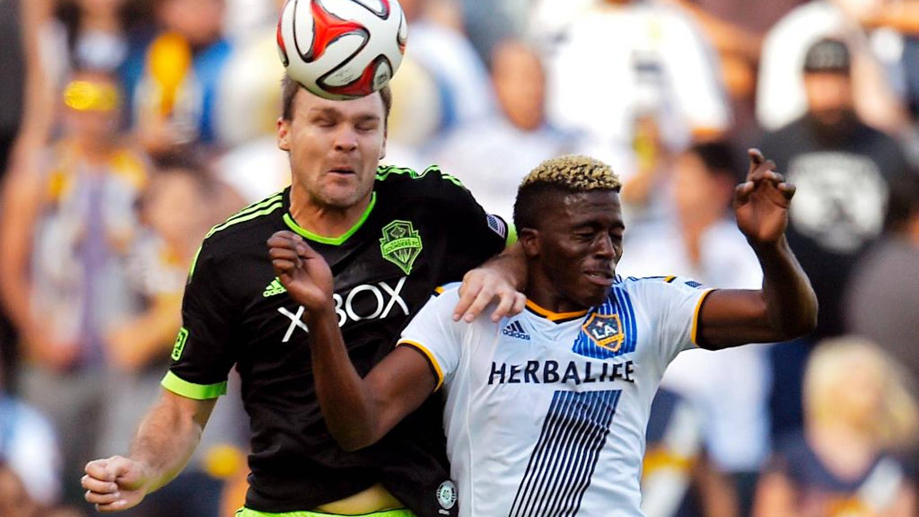 Seattle Sounders FC defender Chad Marshall, left, and Los Angeles Galaxy forward Gyasi Zardes try to head the ball during the first half of a Major League Soccer playoff game, Sunday, Nov. 23, 2014, in Carson, Calif. (AP Photo/Mark J. Terrill)