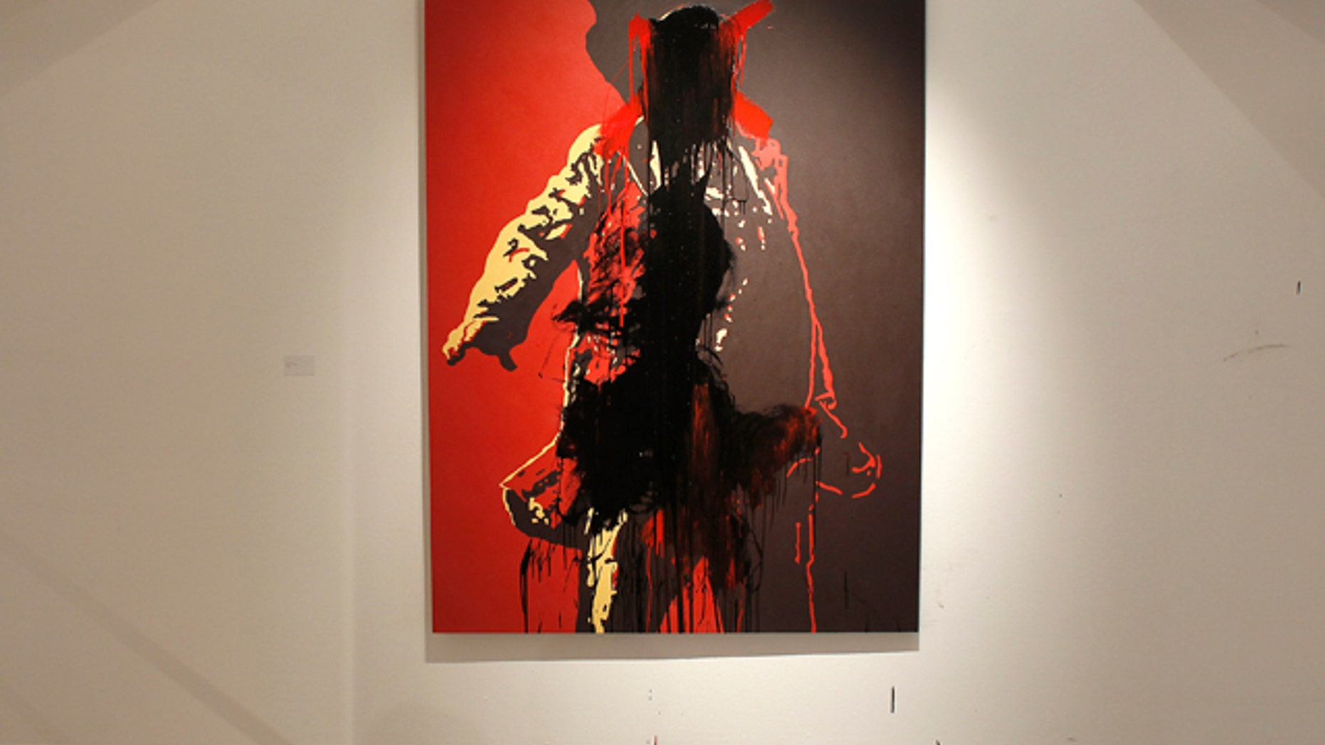 May 22, 2011: An unidentified man defaces a controversial portrait of South African President Jacob Zuma at the Goodman Gallery in Johannesburg, South Africa.